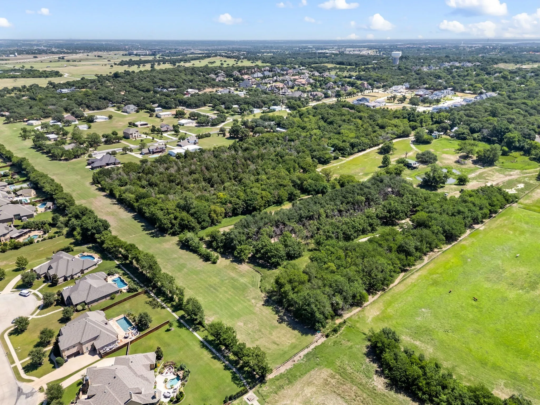 Aerial view of residential area with a tree filled landscape