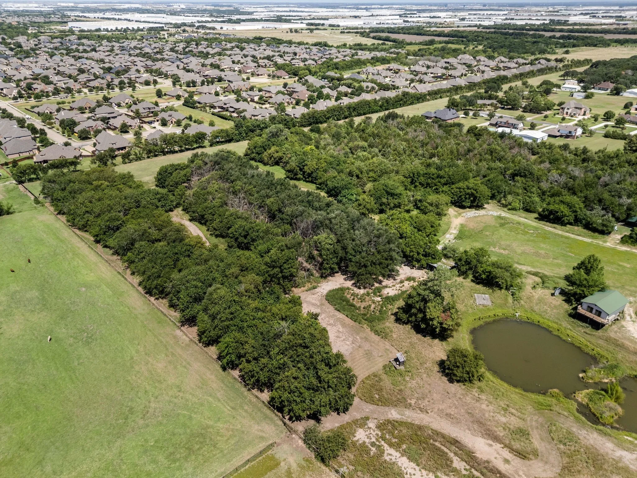 Aerial overview of property's location featuring a nearby body of water and nearby suburban area