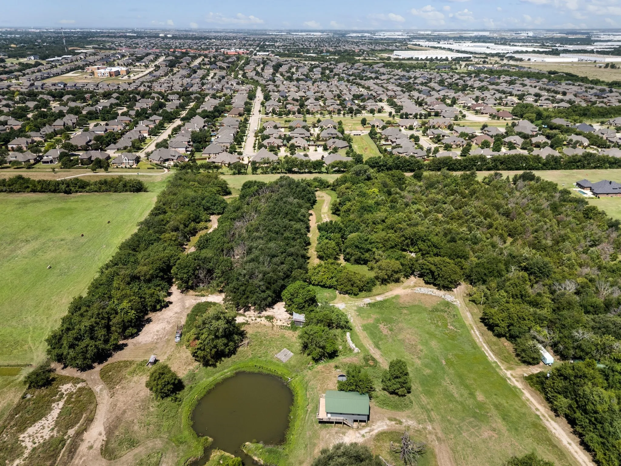 Aerial view of property and surrounding area with a large body of water