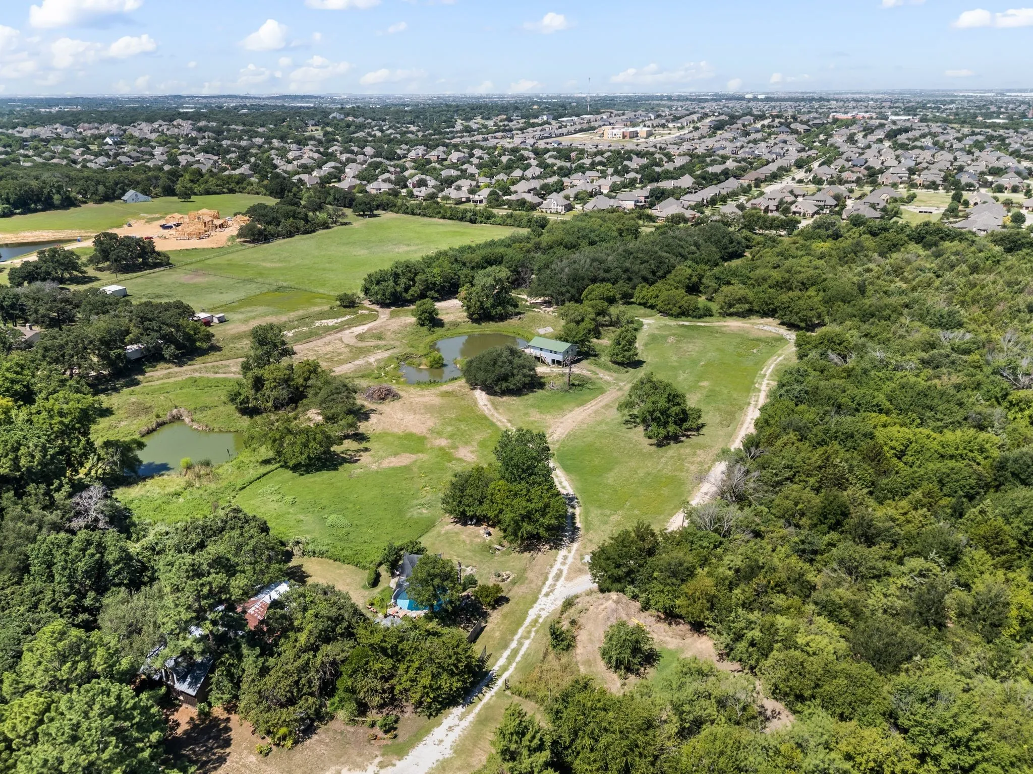 Aerial view of property and surrounding area featuring a large body of water