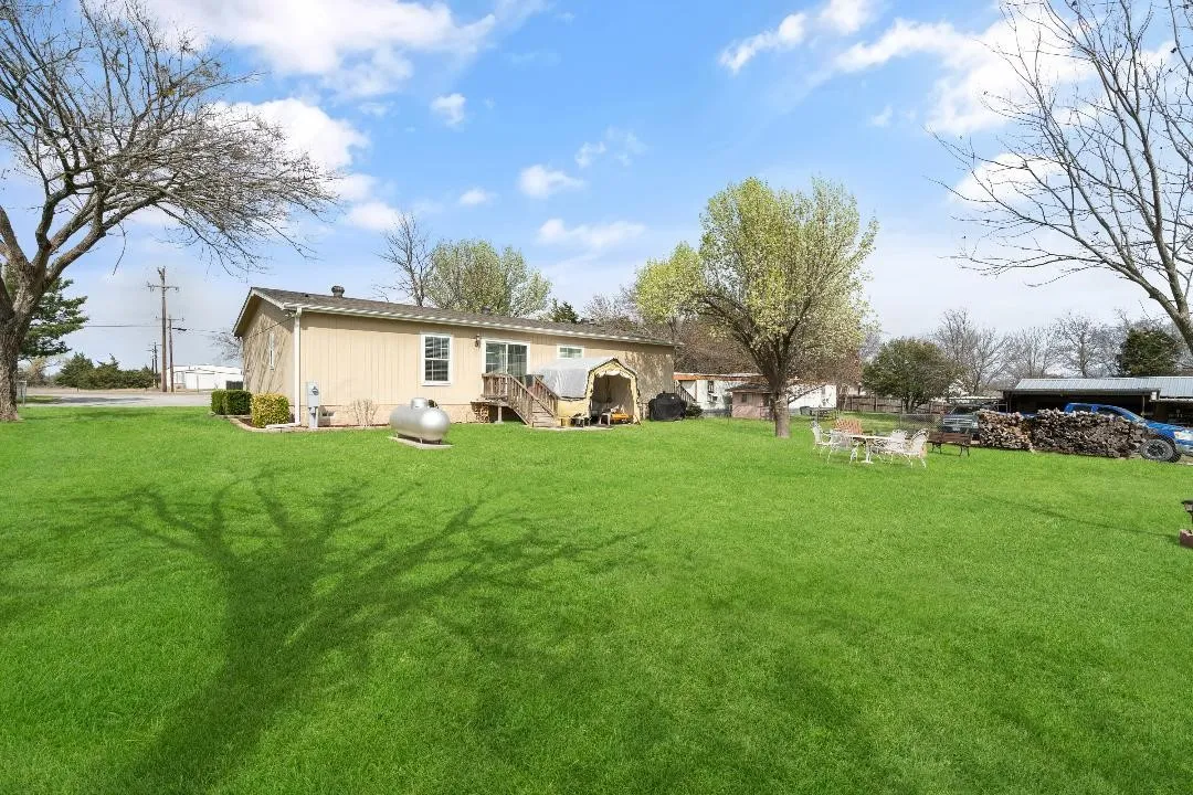 View of green lawn featuring a patio area
