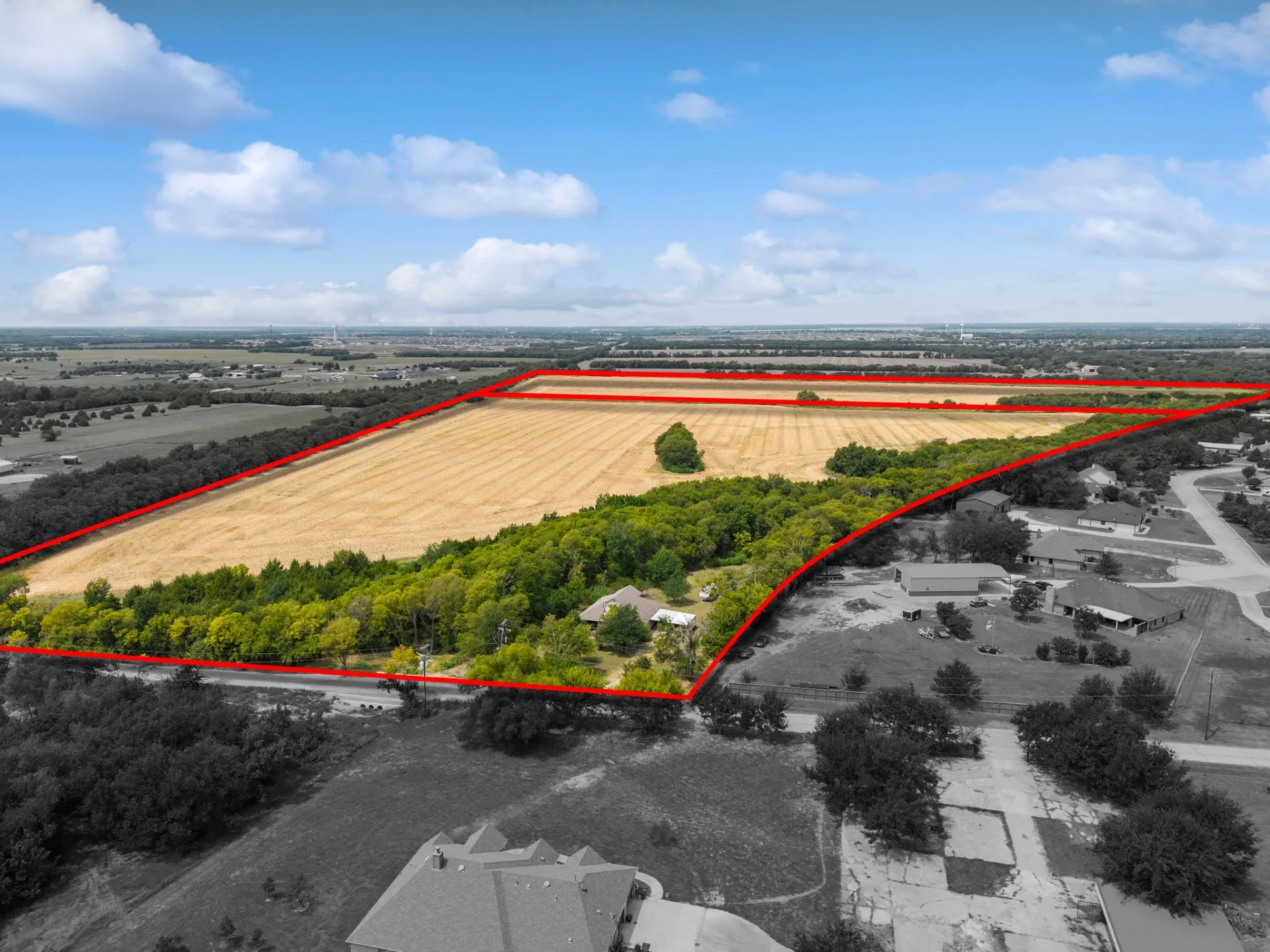 Aerial view of sparsely populated area with property boundaries highlighted