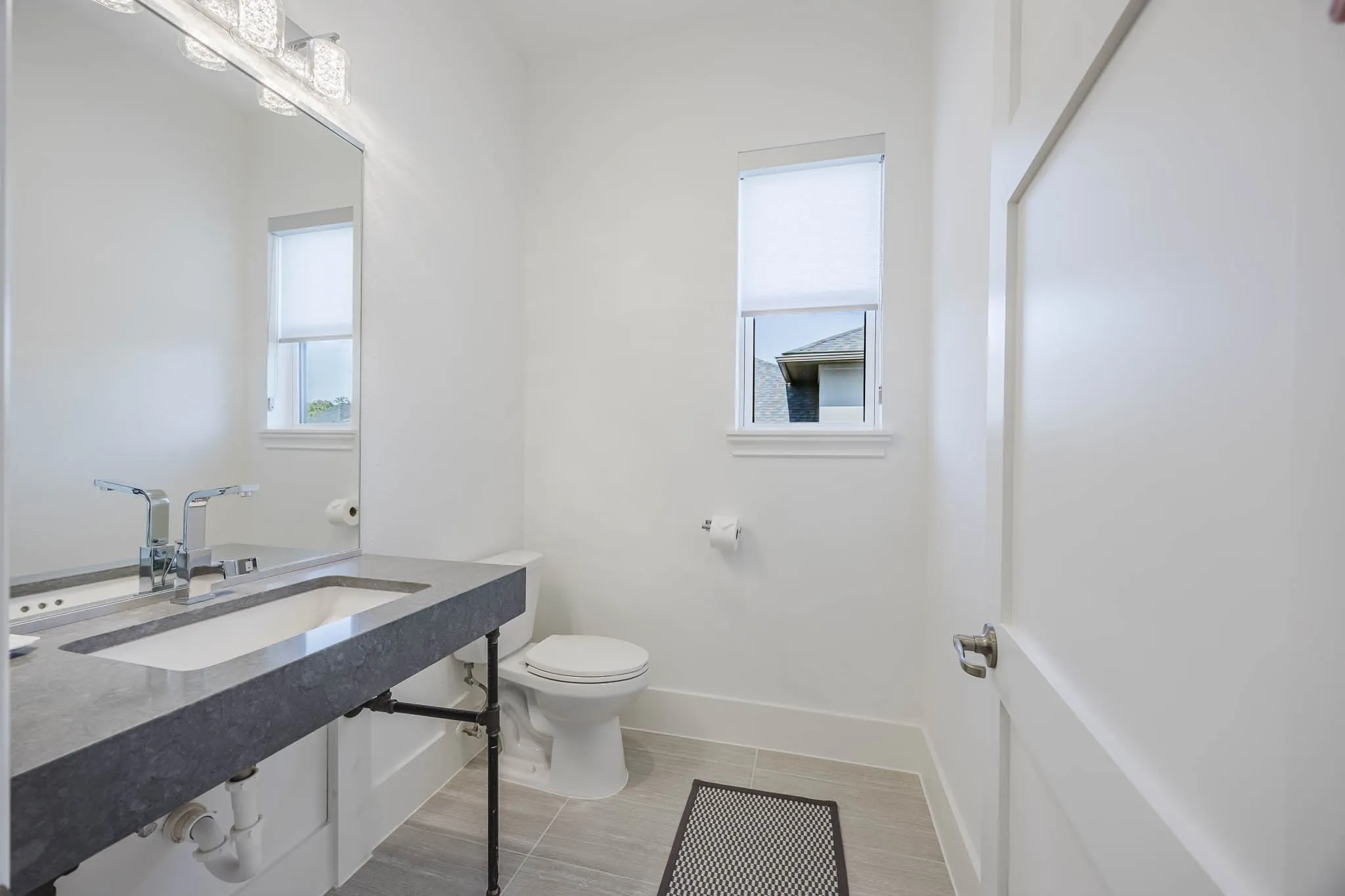 Half bath featuring baseboards and toilet
