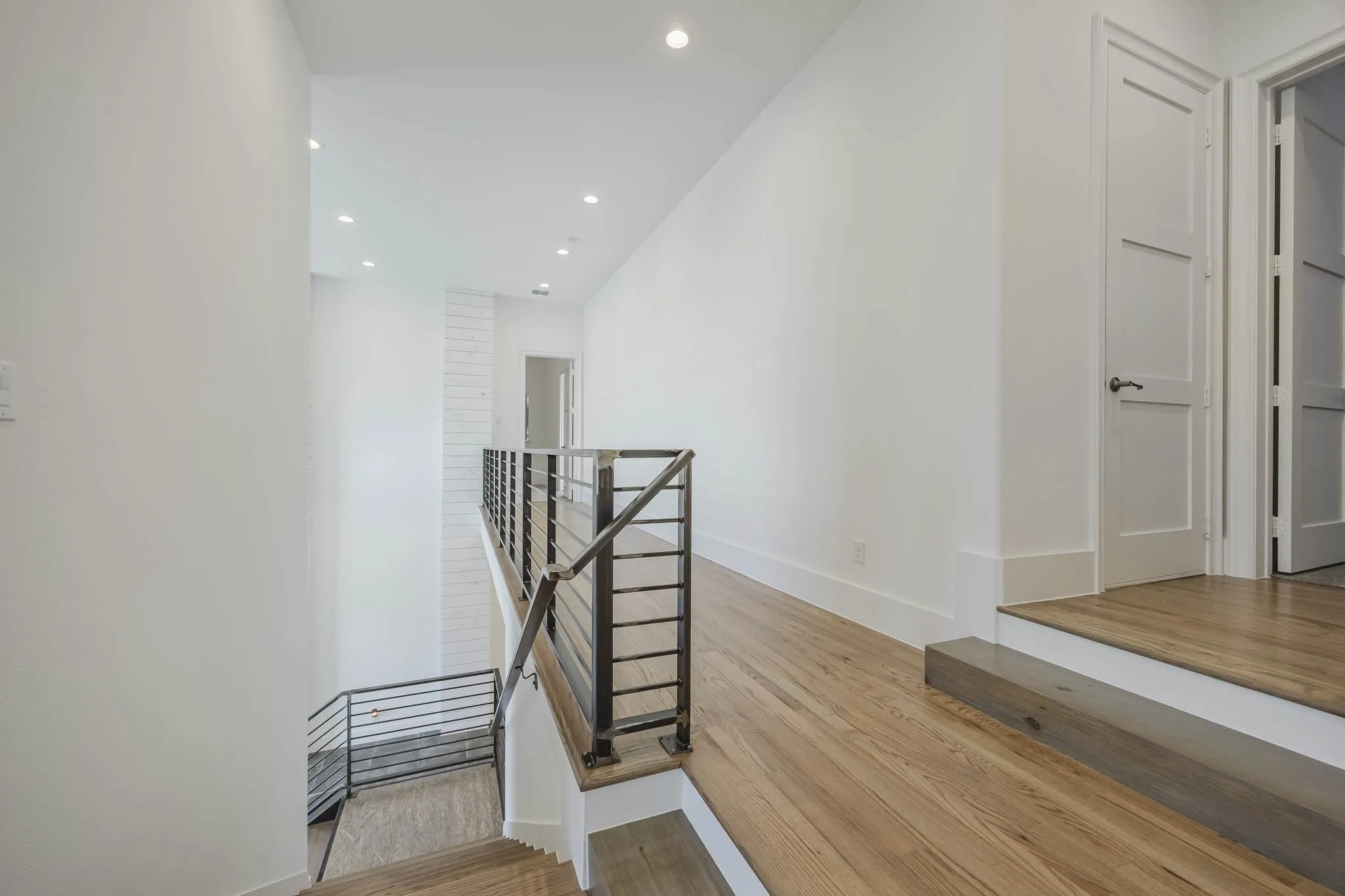 Stairway featuring recessed lighting and wood finished floors