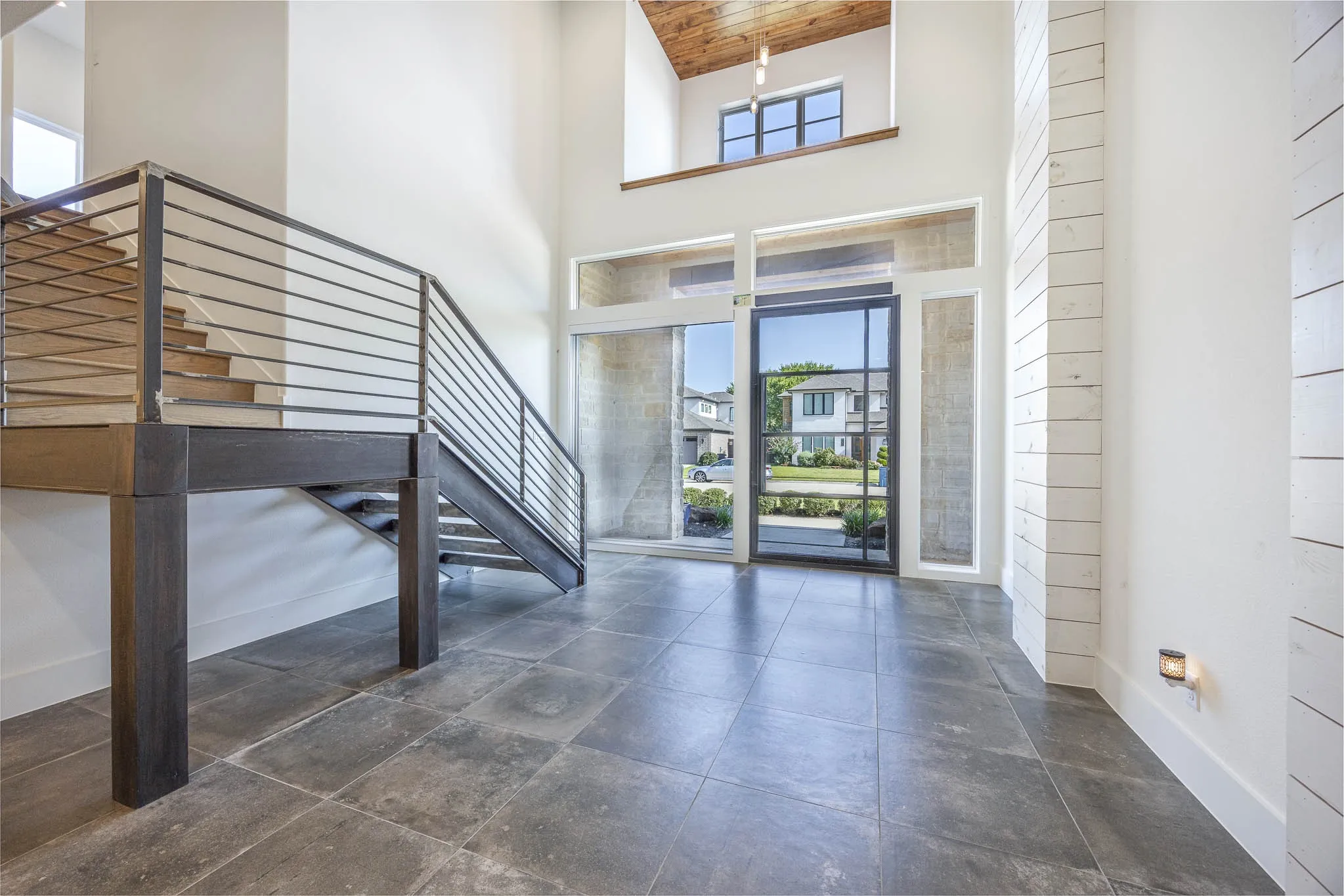 Entrance foyer featuring a high ceiling and wood ceiling