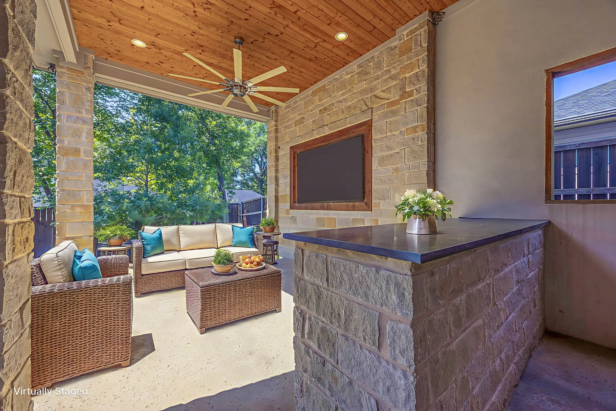 View of patio / terrace with a ceiling fan and an outdoor living space with a fireplace