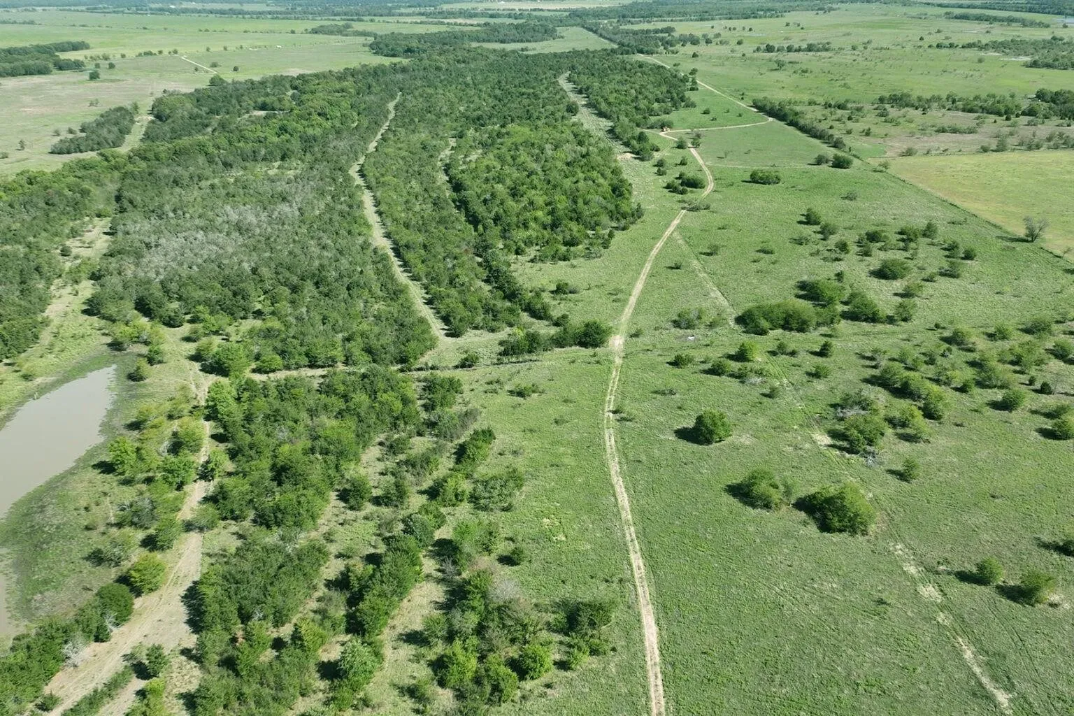 Aerial view of property's location with a large body of water and rural landscape