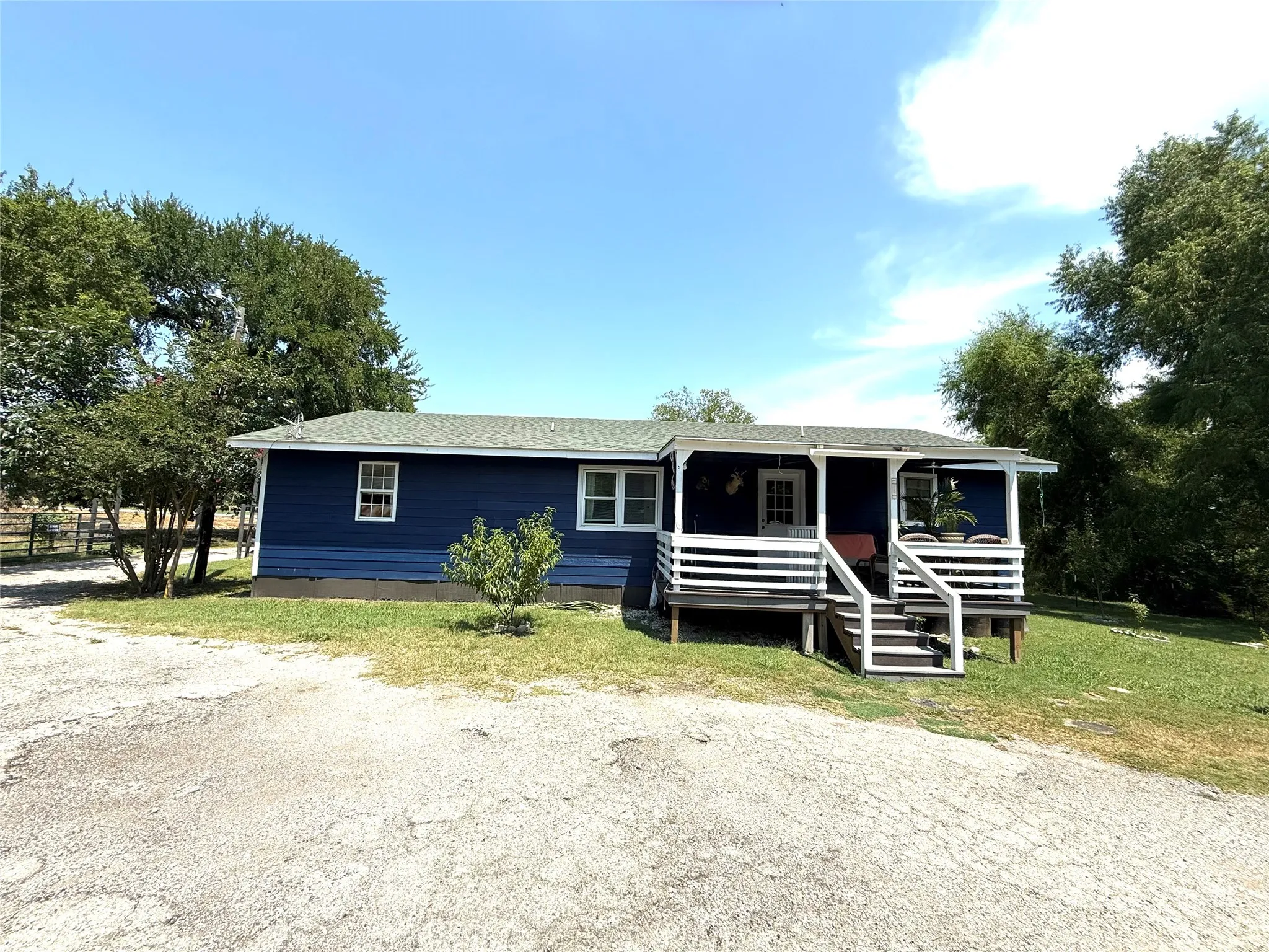 View of front of house featuring a shingled roof and a porch
