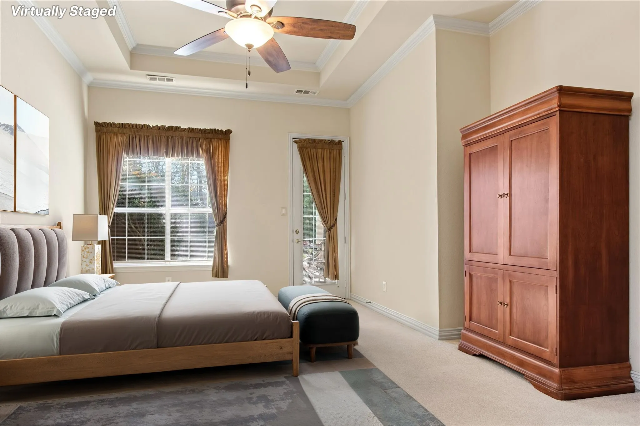 Bedroom featuring a tray ceiling, ceiling fan, crown molding, and a double-pane window