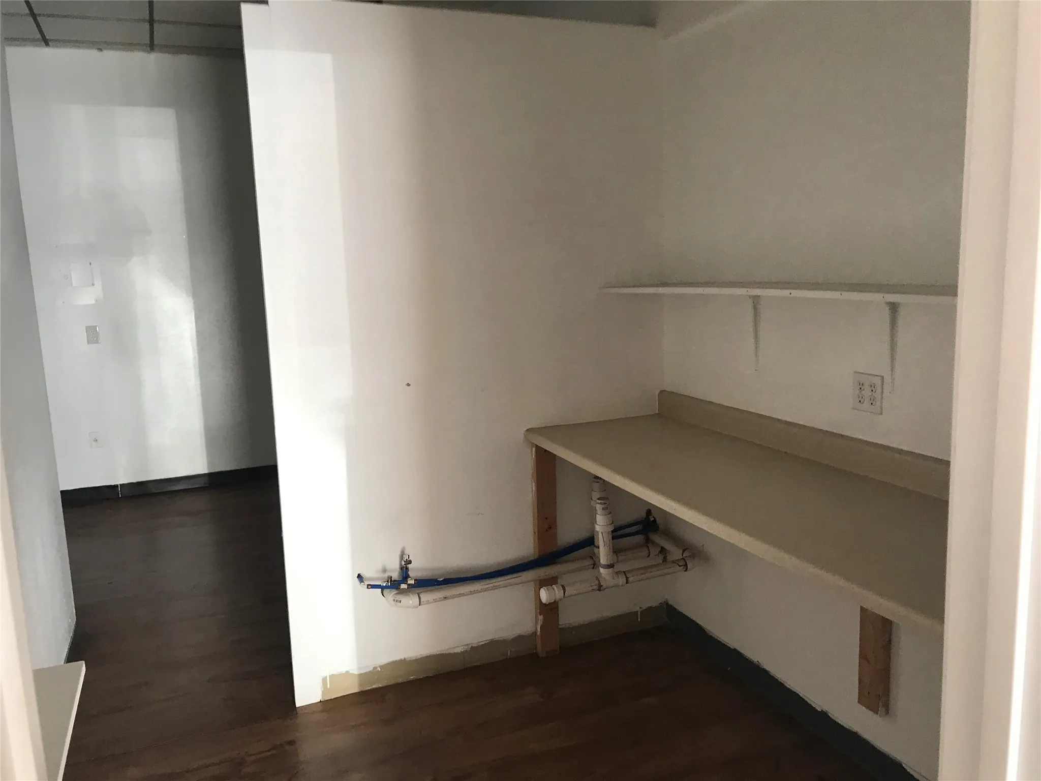 Unfurnished office featuring dark wood-style floors and baseboards