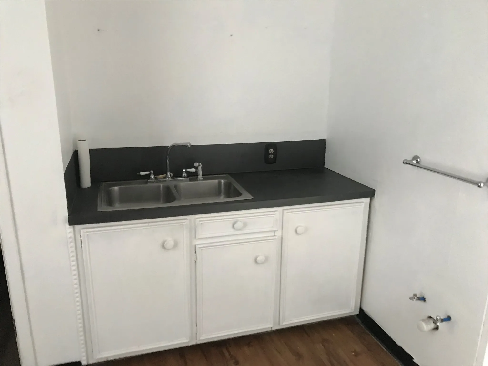 Bathroom with dark wood finished floors and vanity