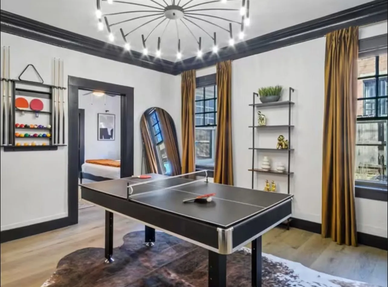 Recreation room with crown molding, plenty of natural light, and light wood-type flooring