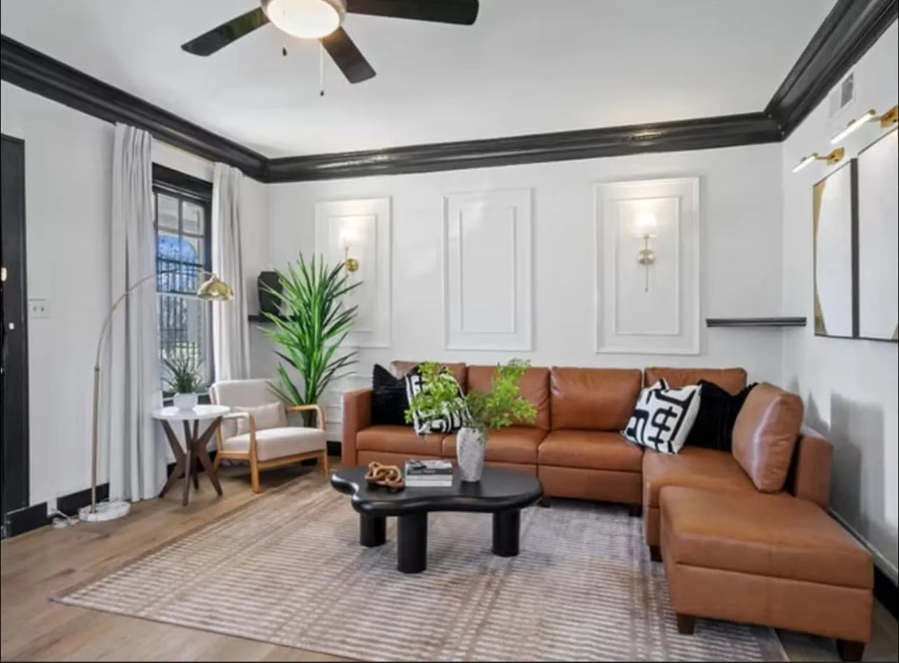 Living room with ornamental molding, wood finished floors, and ceiling fan