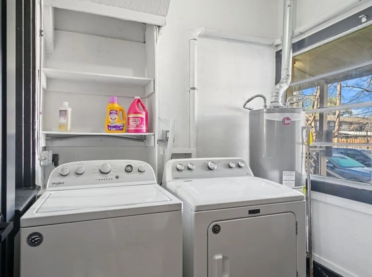 Laundry room with washing machine and clothes dryer and gas water heater