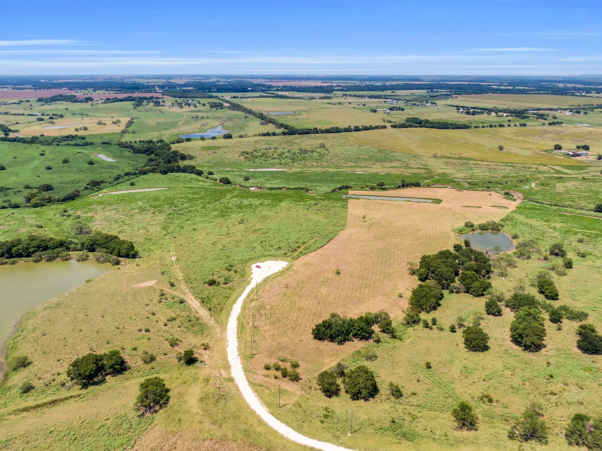 Aerial overview of property's location featuring a large body of water and rural landscape