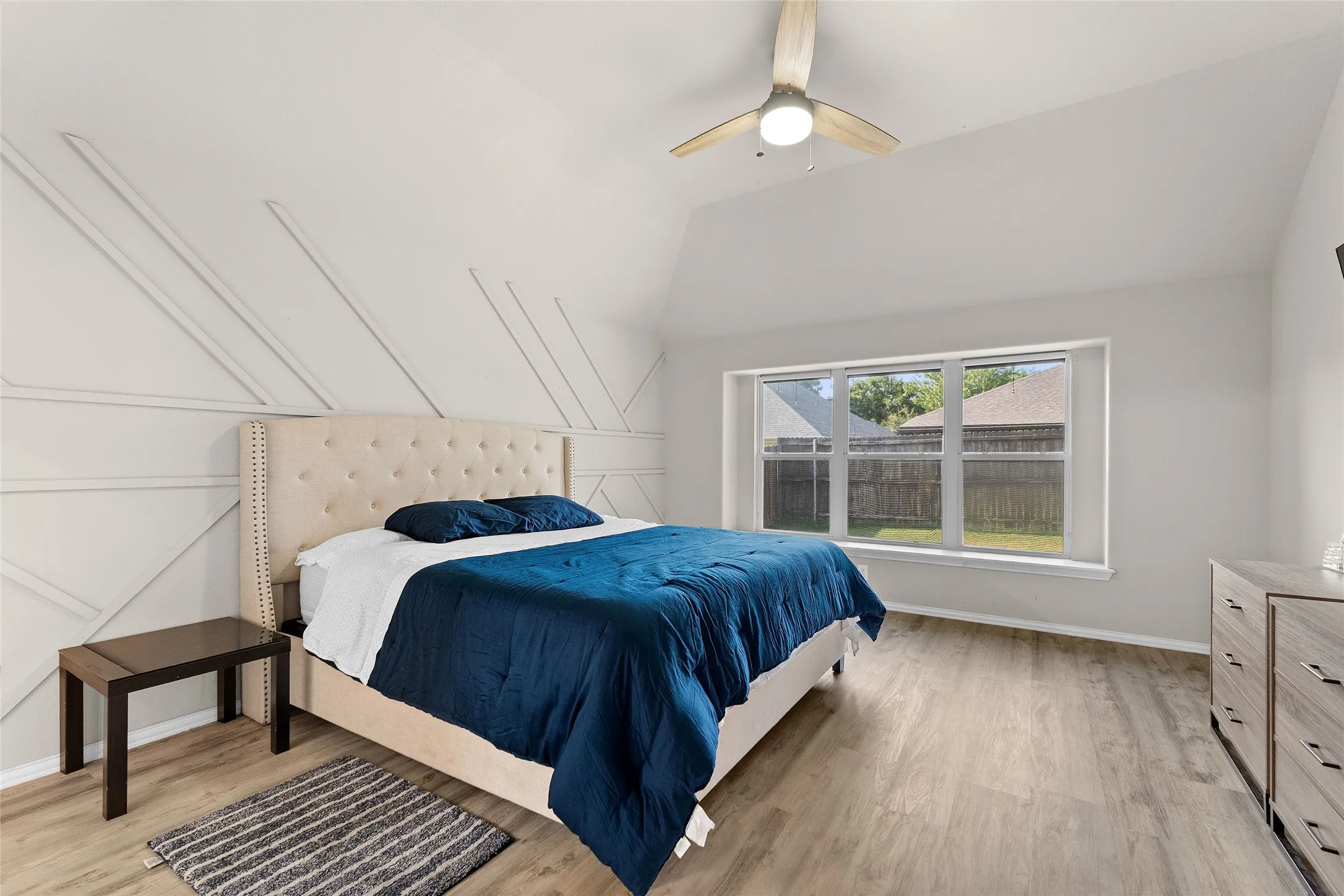 Bedroom featuring lofted ceiling, light wood-type flooring, and ceiling fan