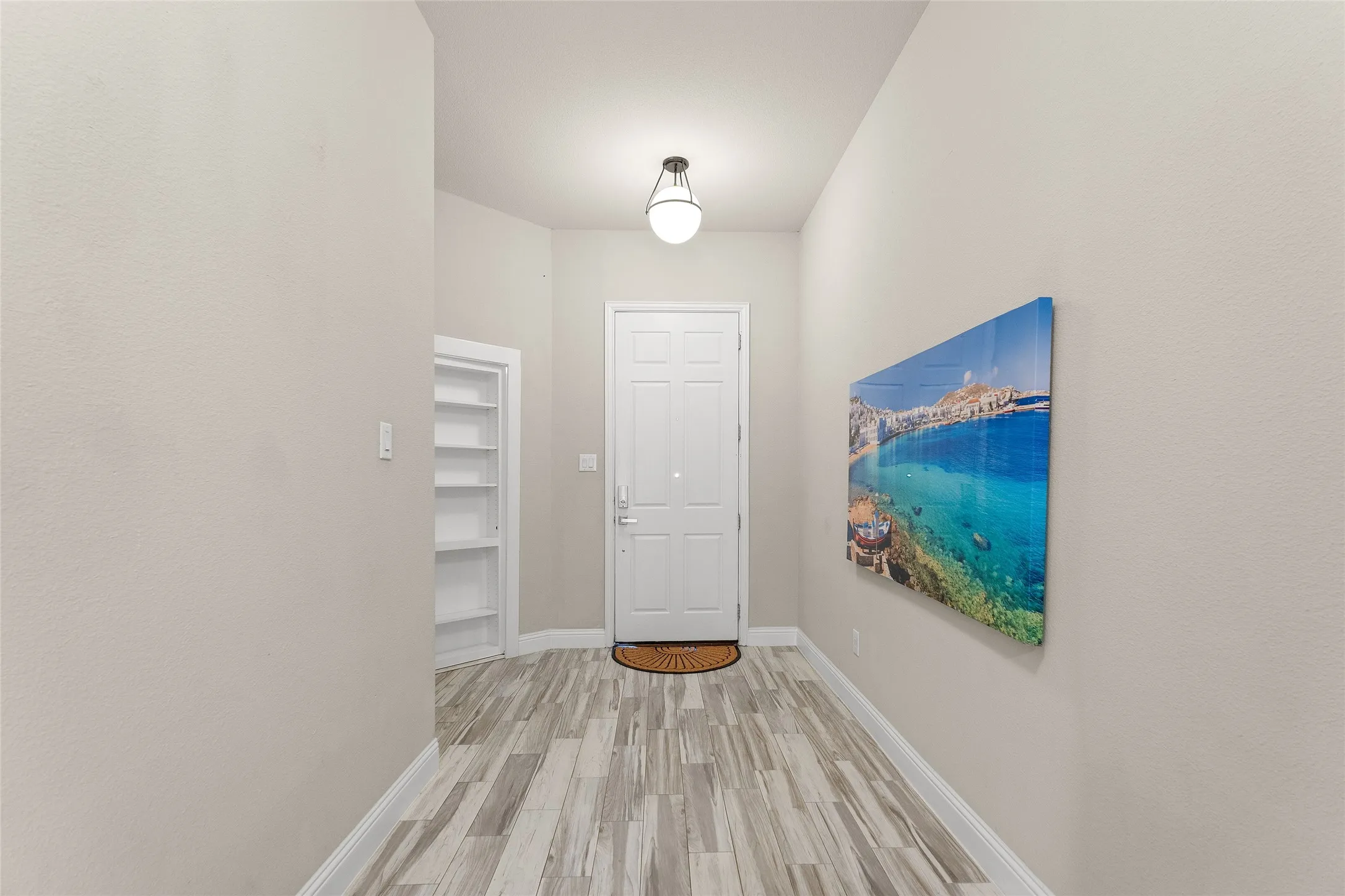 Hall featuring light wood-type flooring and baseboards