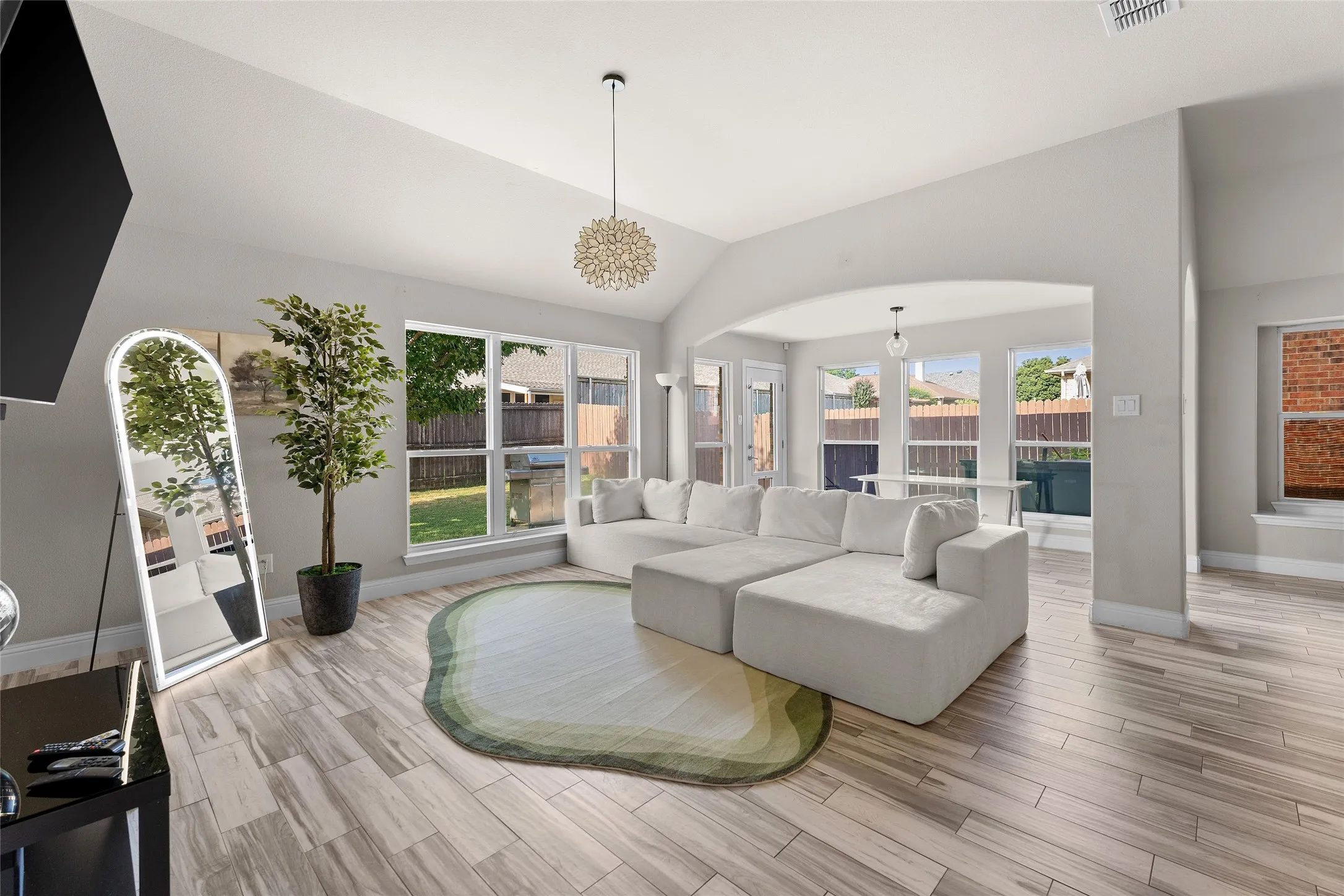 Living area featuring lofted ceiling and light wood finished floors