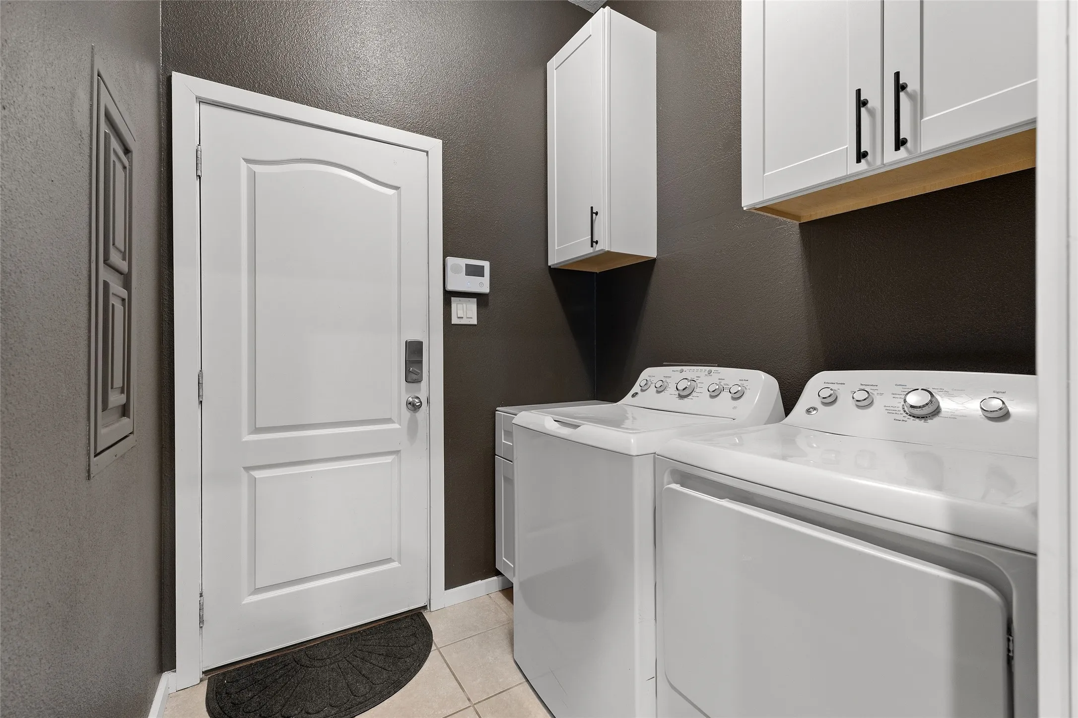 Kitchen with backsplash, dark stone countertops, appliances with stainless steel finishes, white cabinets, and recessed lighting