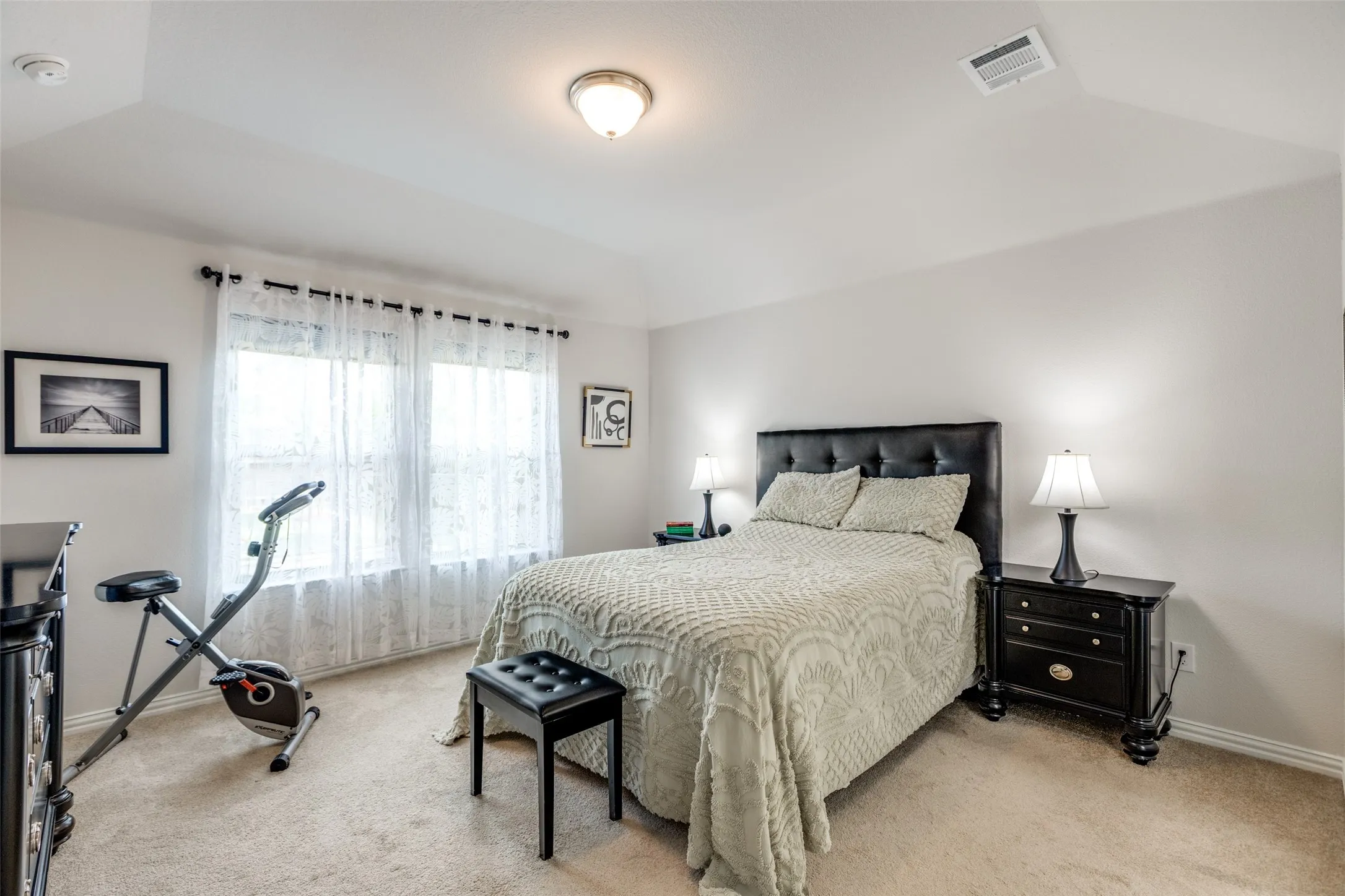 Bedroom with baseboards and light carpet