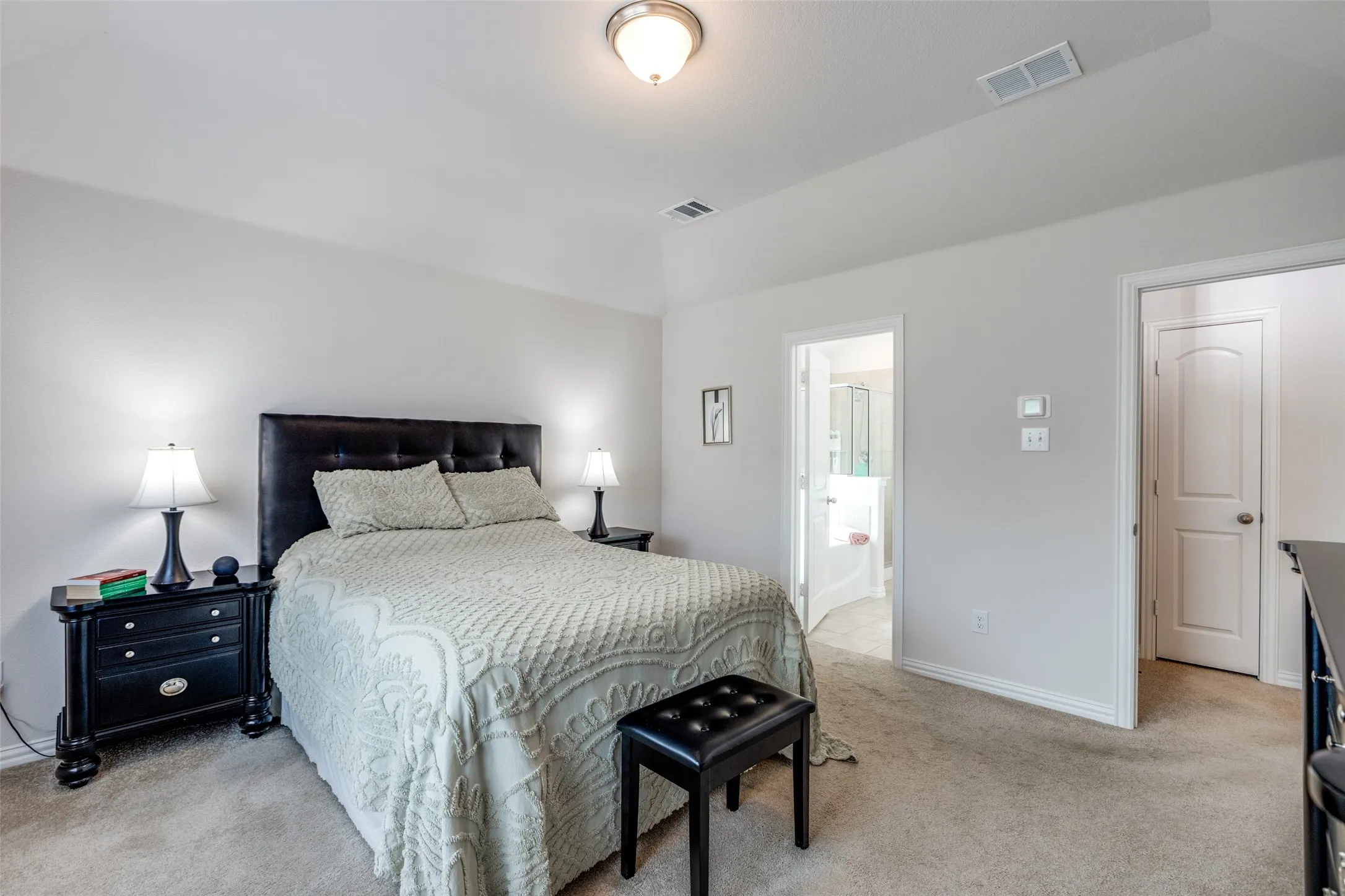 Bedroom with light carpet and baseboards
