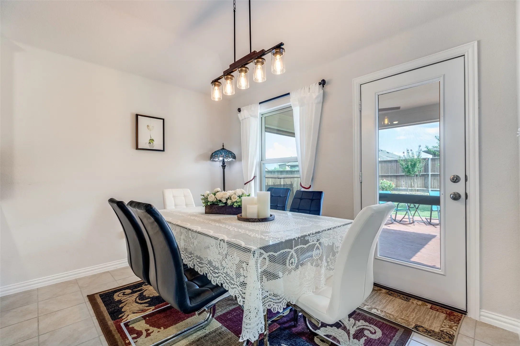 Dining room featuring light tile patterned flooring and baseboards