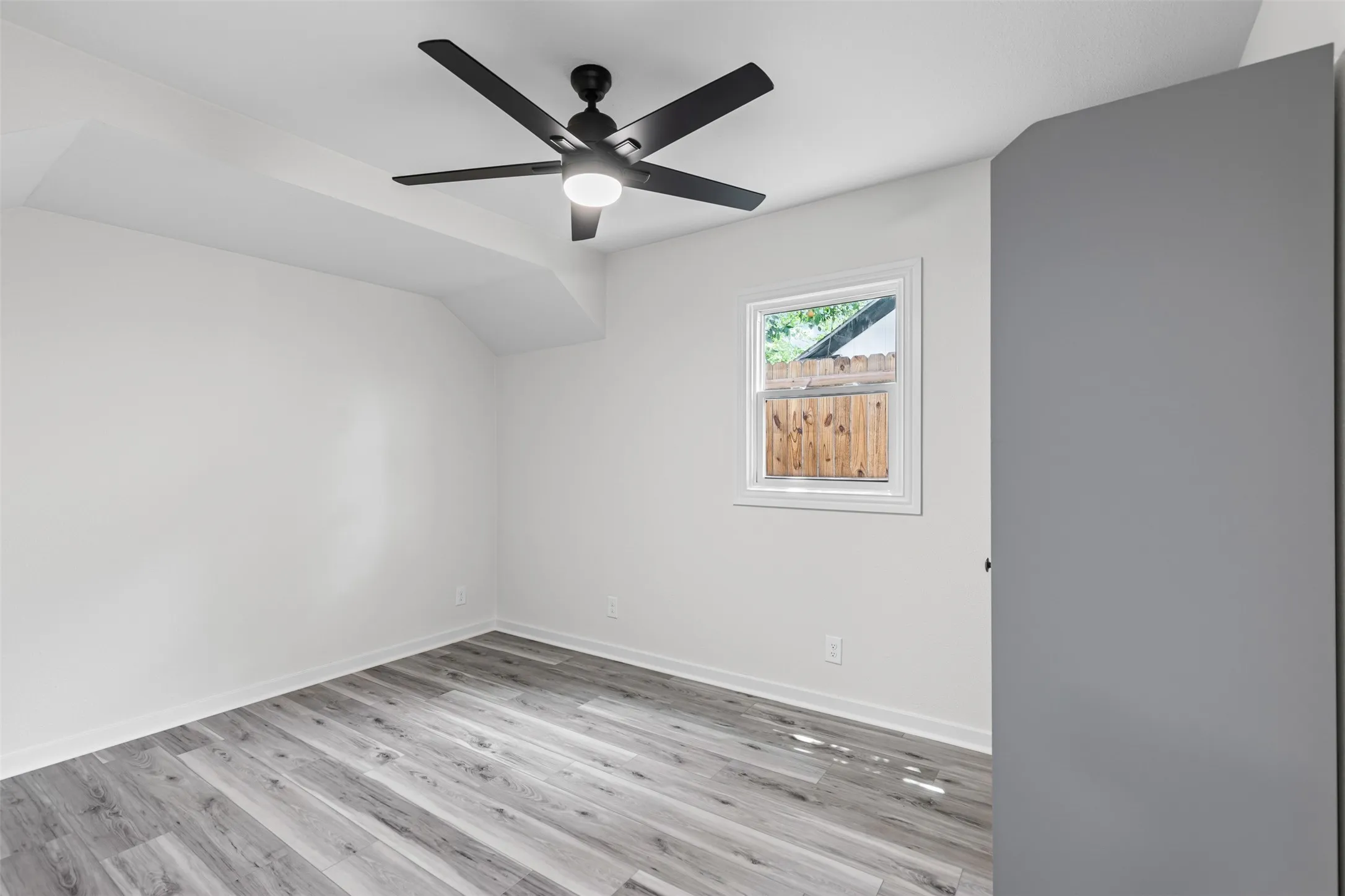 Spare room with light wood-style flooring and ceiling fan