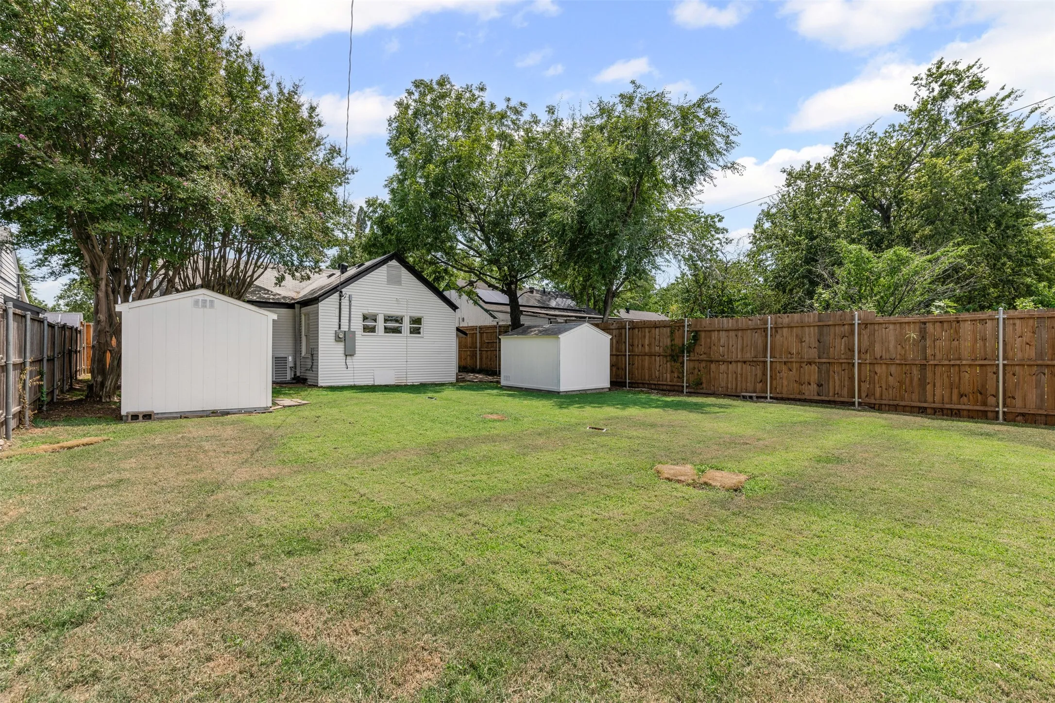 Fenced backyard with a shed