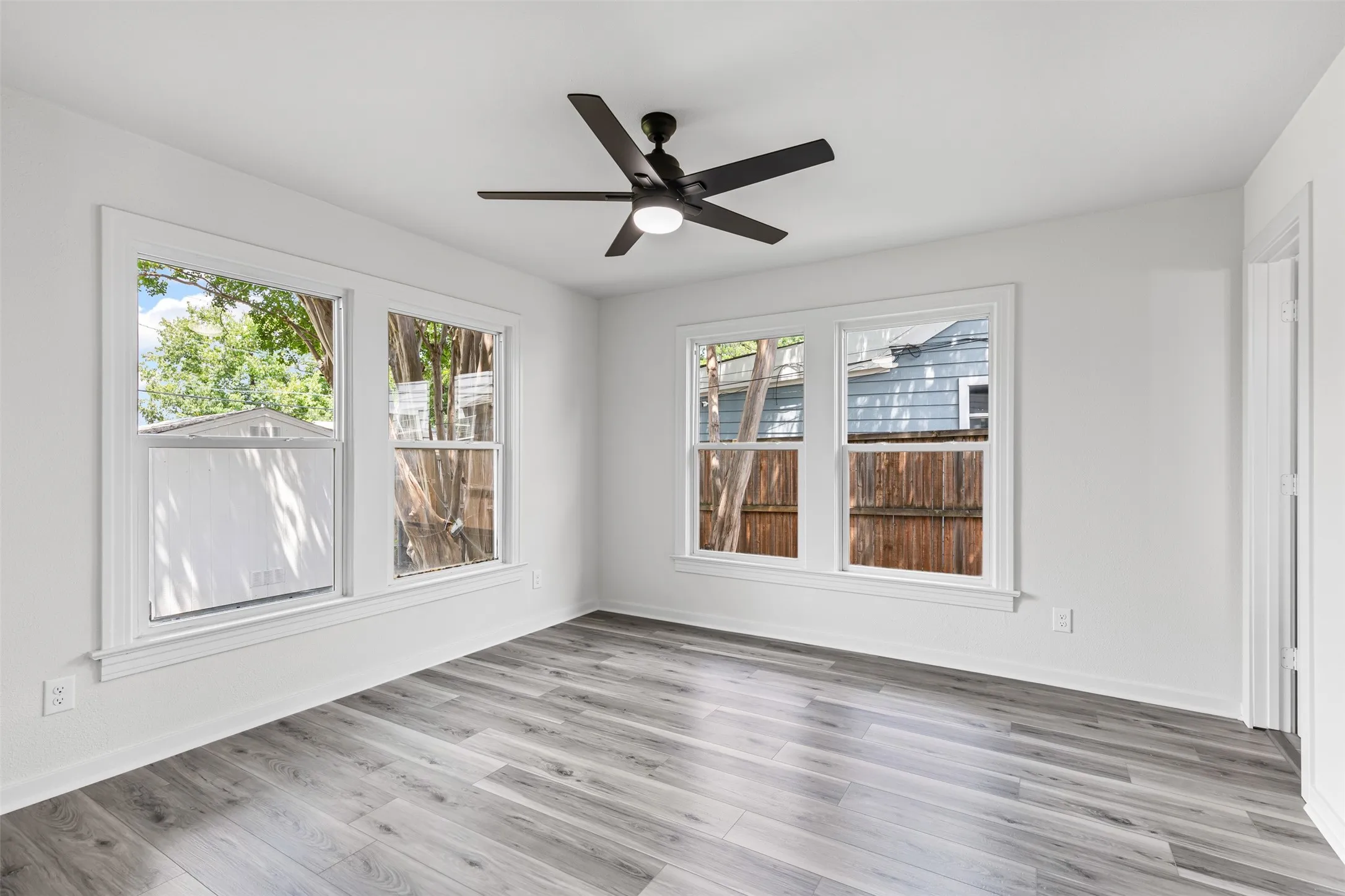 Spare room with light wood-style floors and a ceiling fan