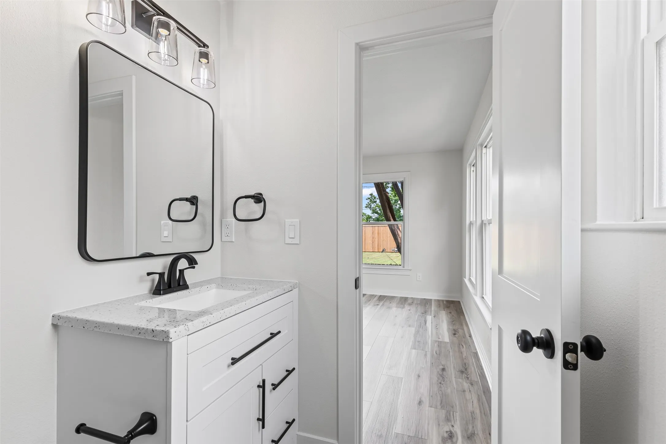 Half bath featuring vanity and light wood-style flooring
