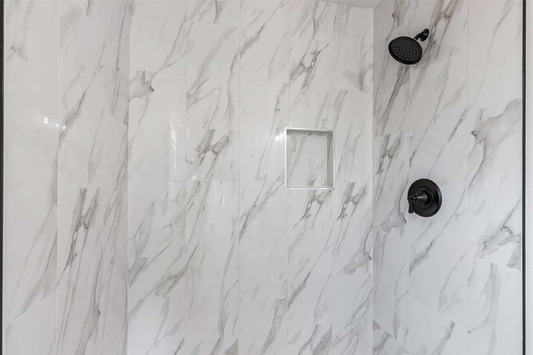 Bathroom view of a marble finish shower