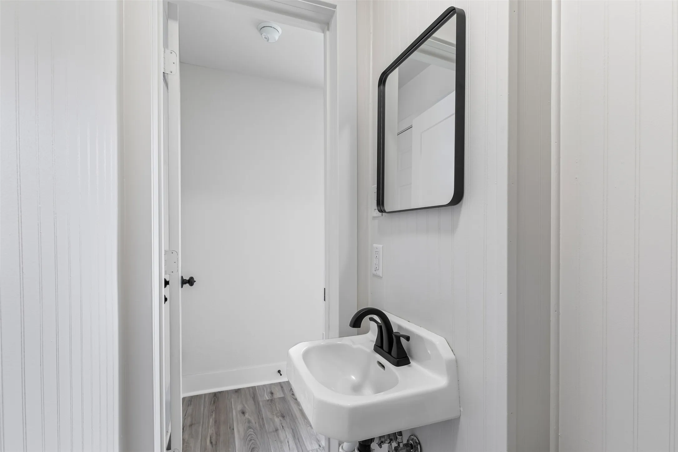 Bathroom with wood finished floors and a sink