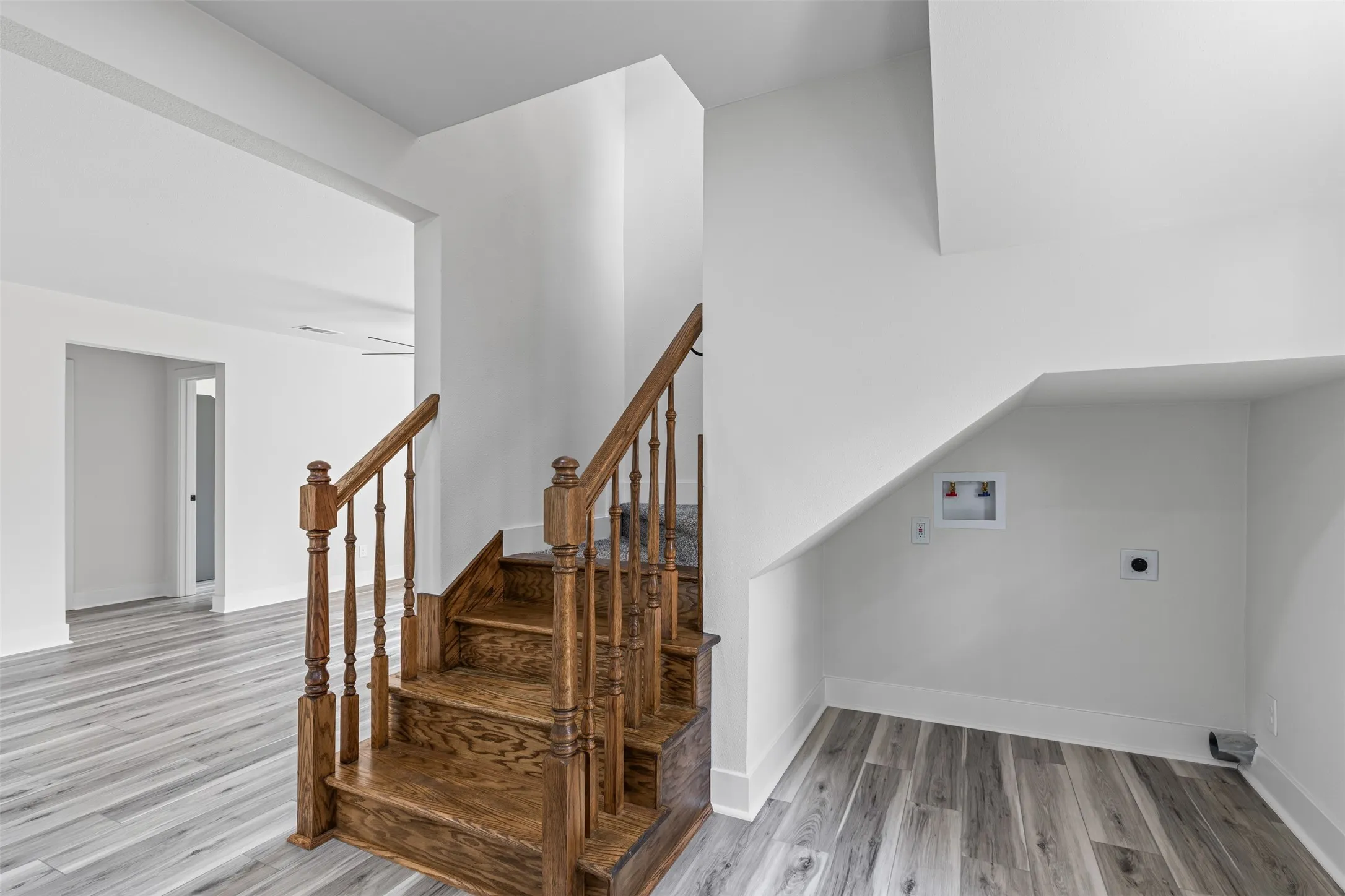 Staircase featuring wood finished floors and baseboards