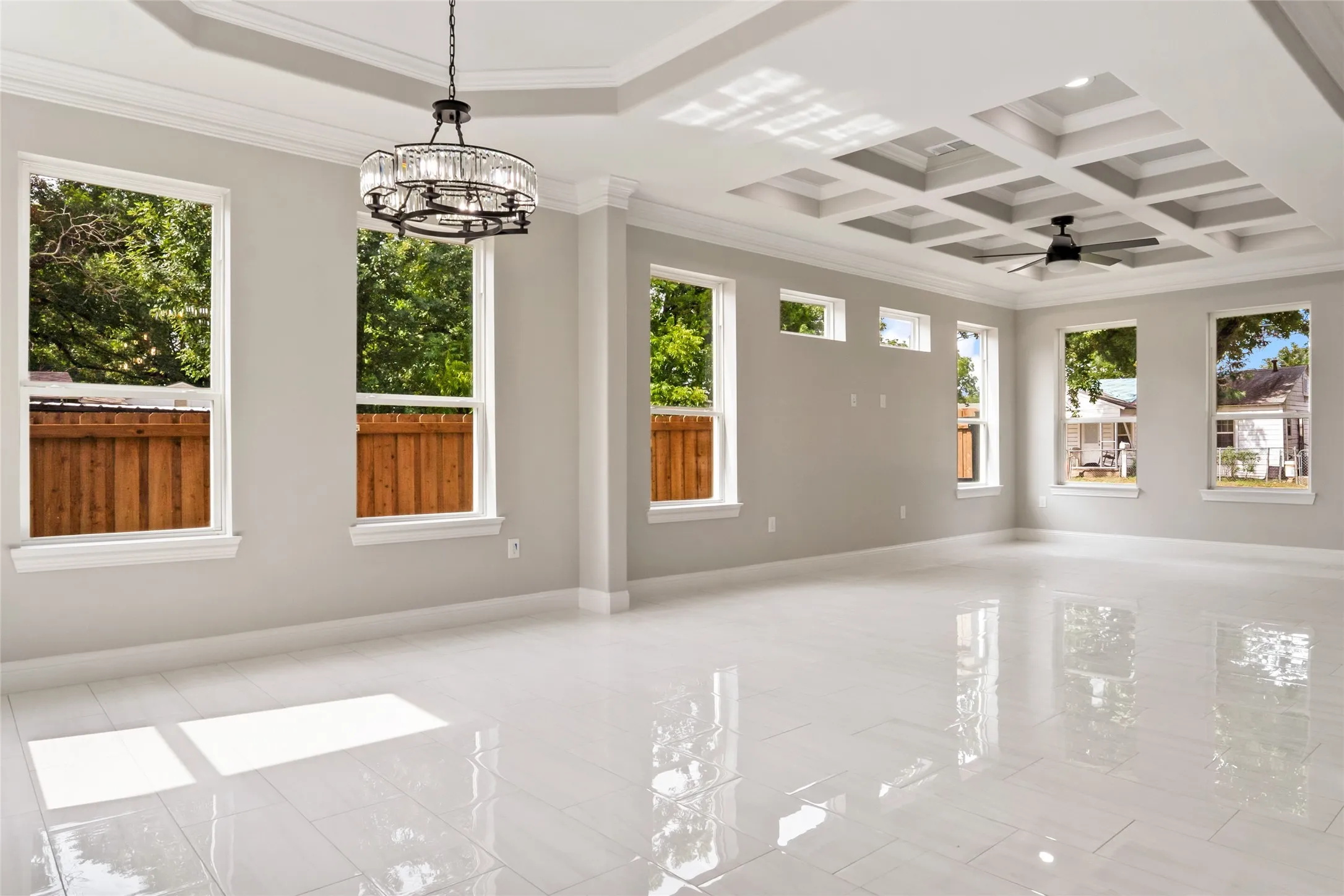 Unfurnished sunroom featuring coffered ceiling, beamed ceiling, and a chandelier
