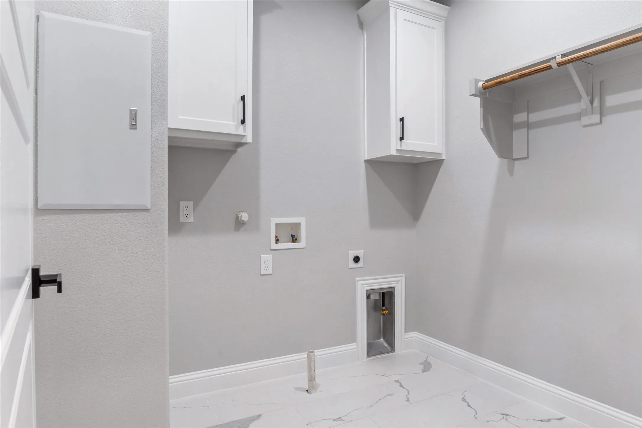 Spacious Utility Room with custom solid wood cabinets, Custom Tile and Full Size Washer & Dryer hookup for a Gas or Electric dryer
