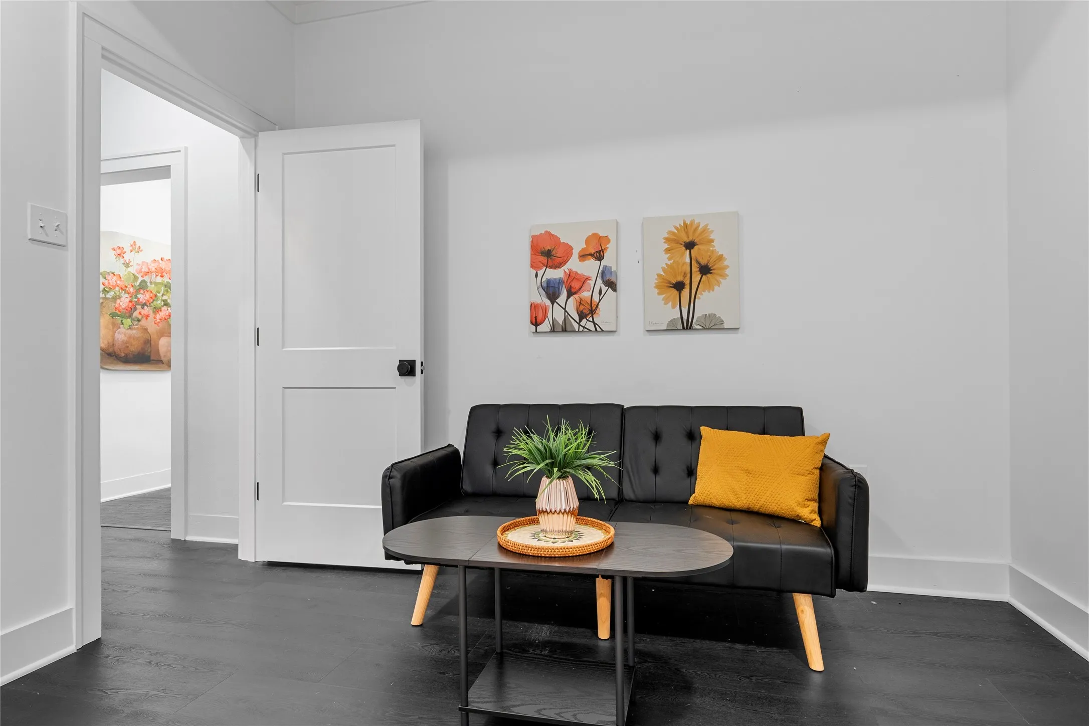 Sitting room featuring dark wood-type flooring