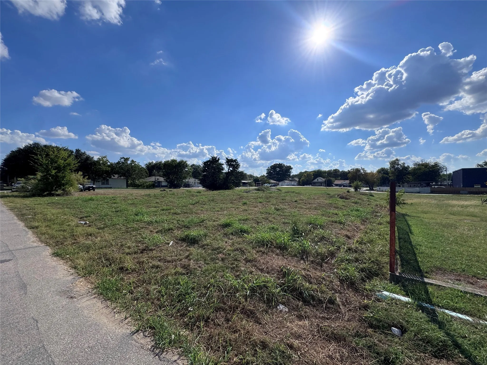 View of asphalt street with a view of rural / pastoral area