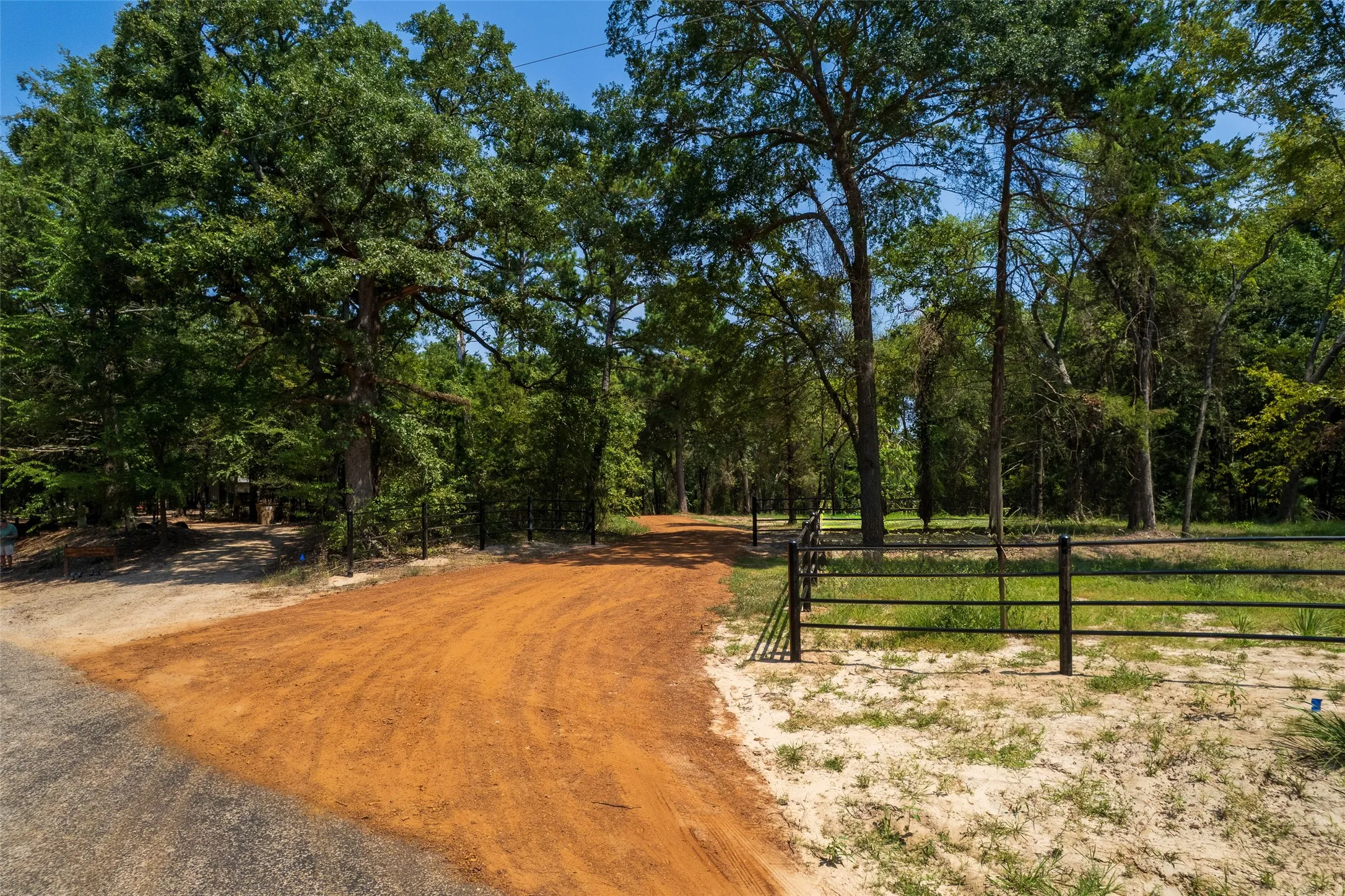 View of street with a gate and a view of trees