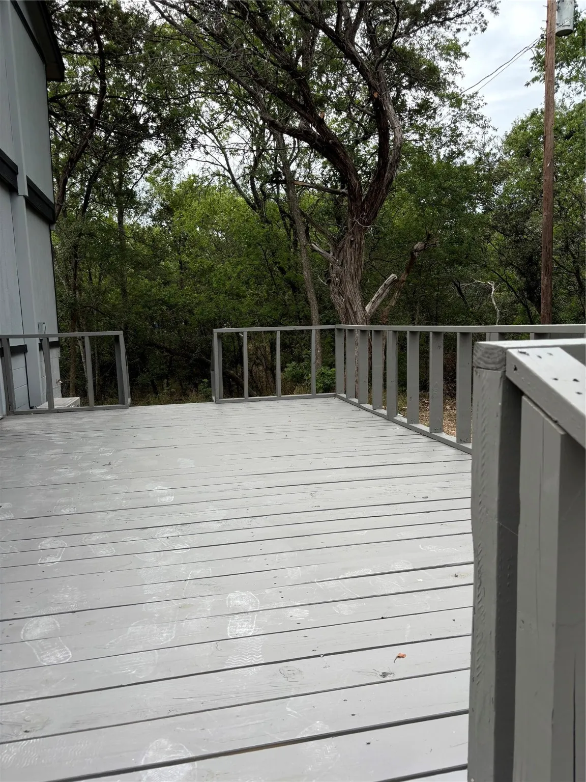 Large deck looks onto wooded area