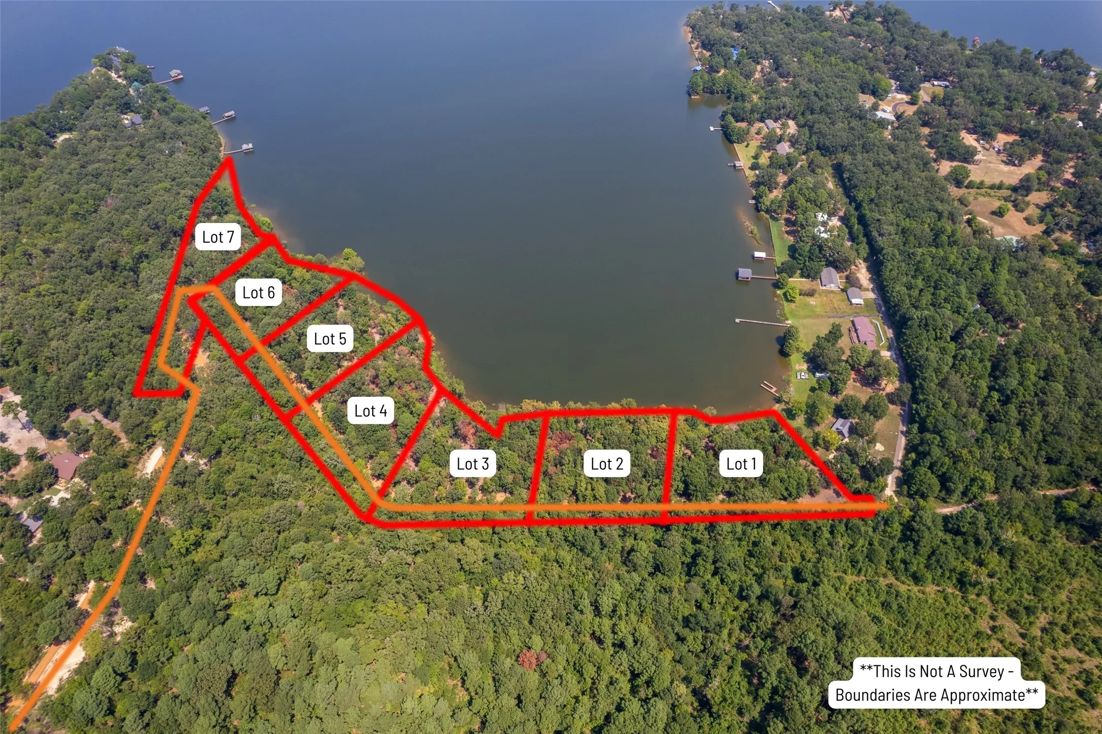 Aerial view of property and surrounding area with property parcel outlined and a nearby body of water