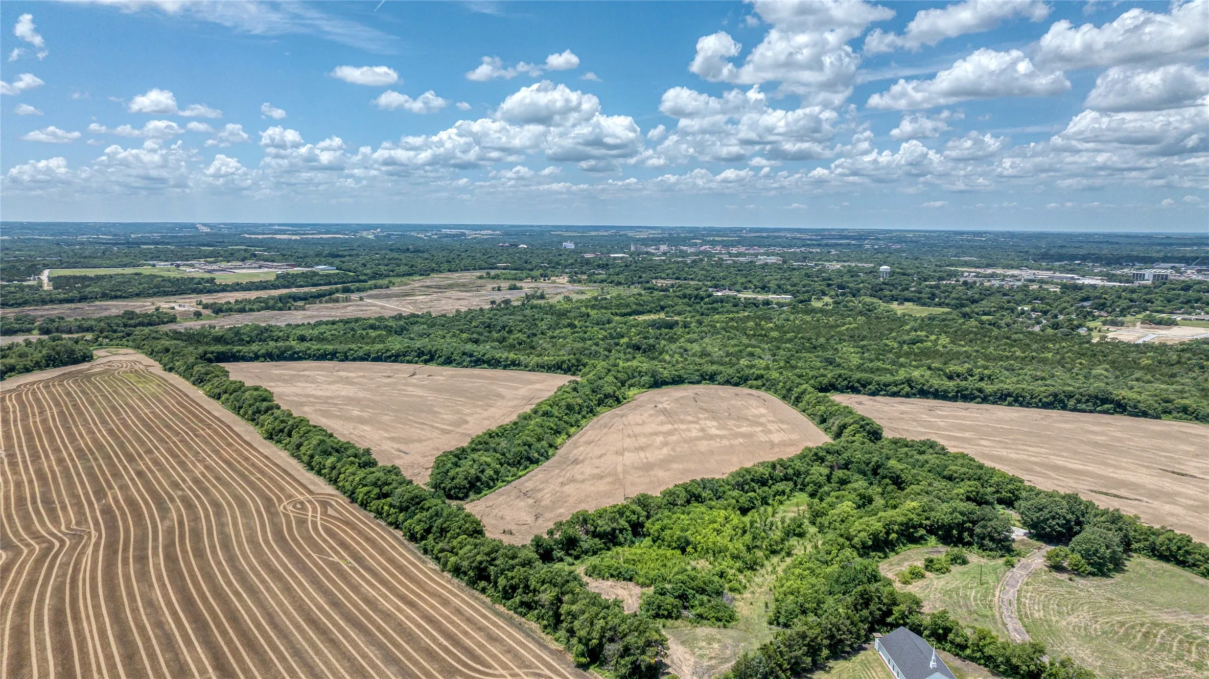 Aerial view of sparsely populated area with extensive farmland