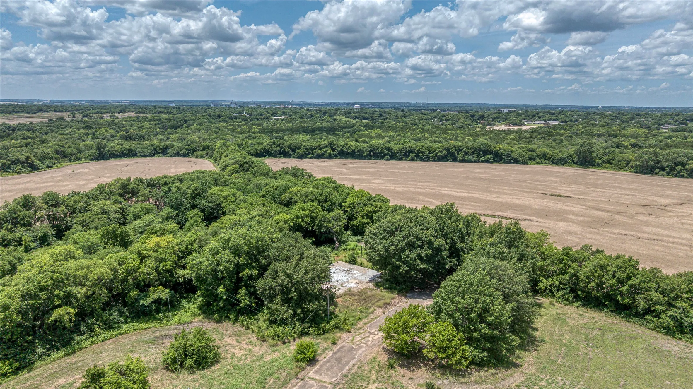 View of rural area with a heavily wooded area