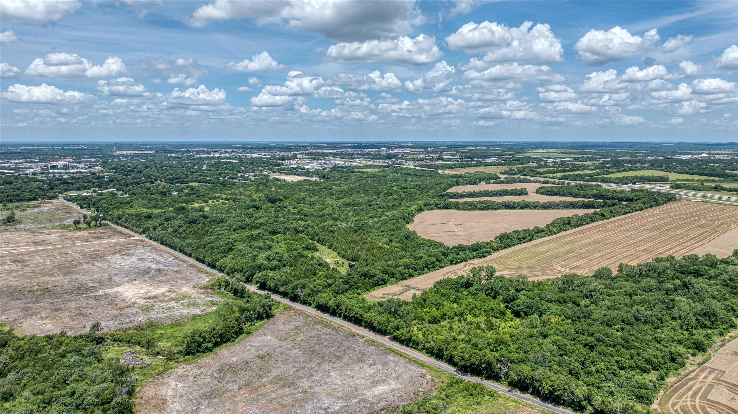Overview of rural landscape featuring large plots for crops