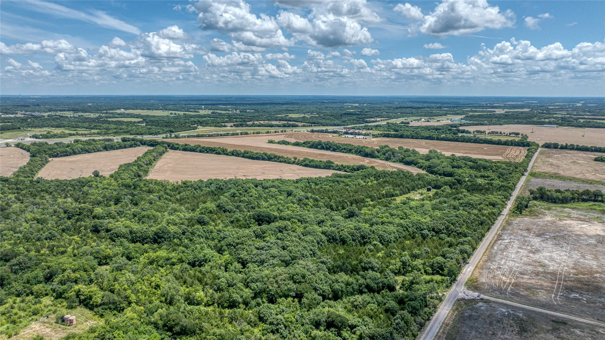 Overview of rural landscape with a forest and farmland