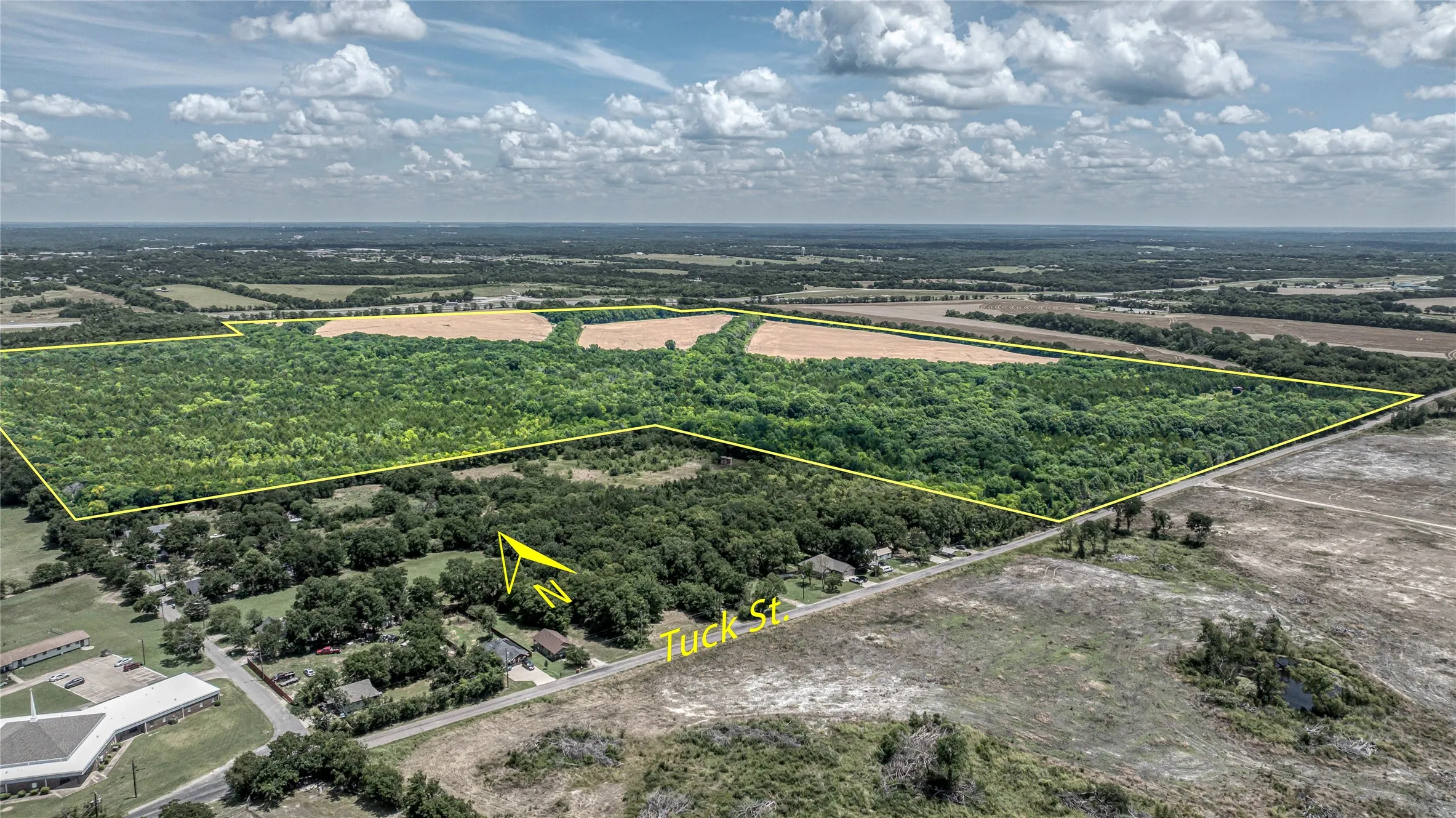 Aerial view of sparsely populated area with property boundaries highlighted