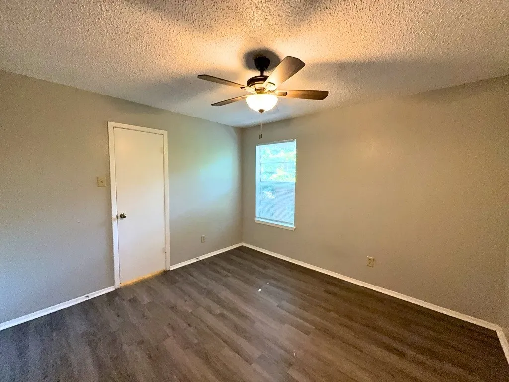 Bedroom with ceiling fan and closet