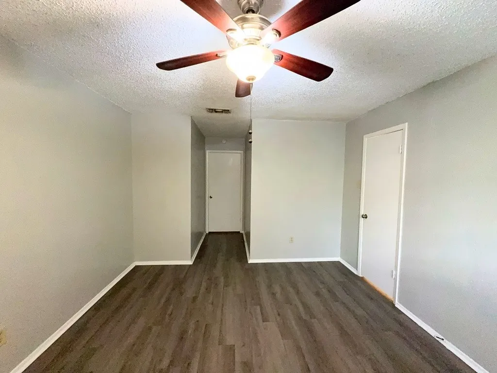 Second bedroom with ceiling fan and closet