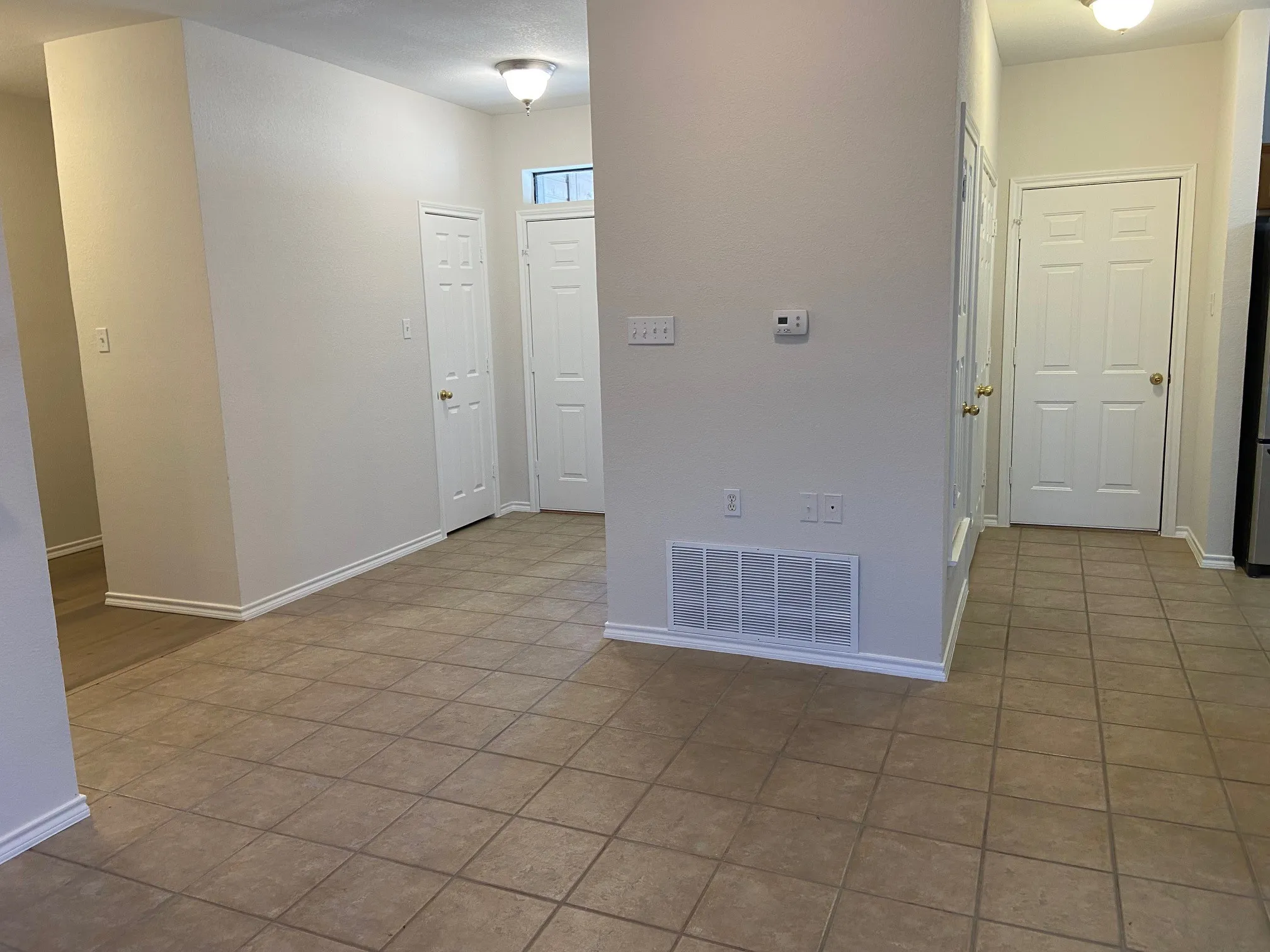 Front door and door to the garage standing in the living area.