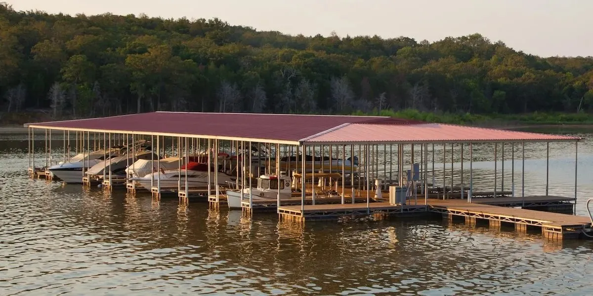 Dock area with a water view and a wooded view