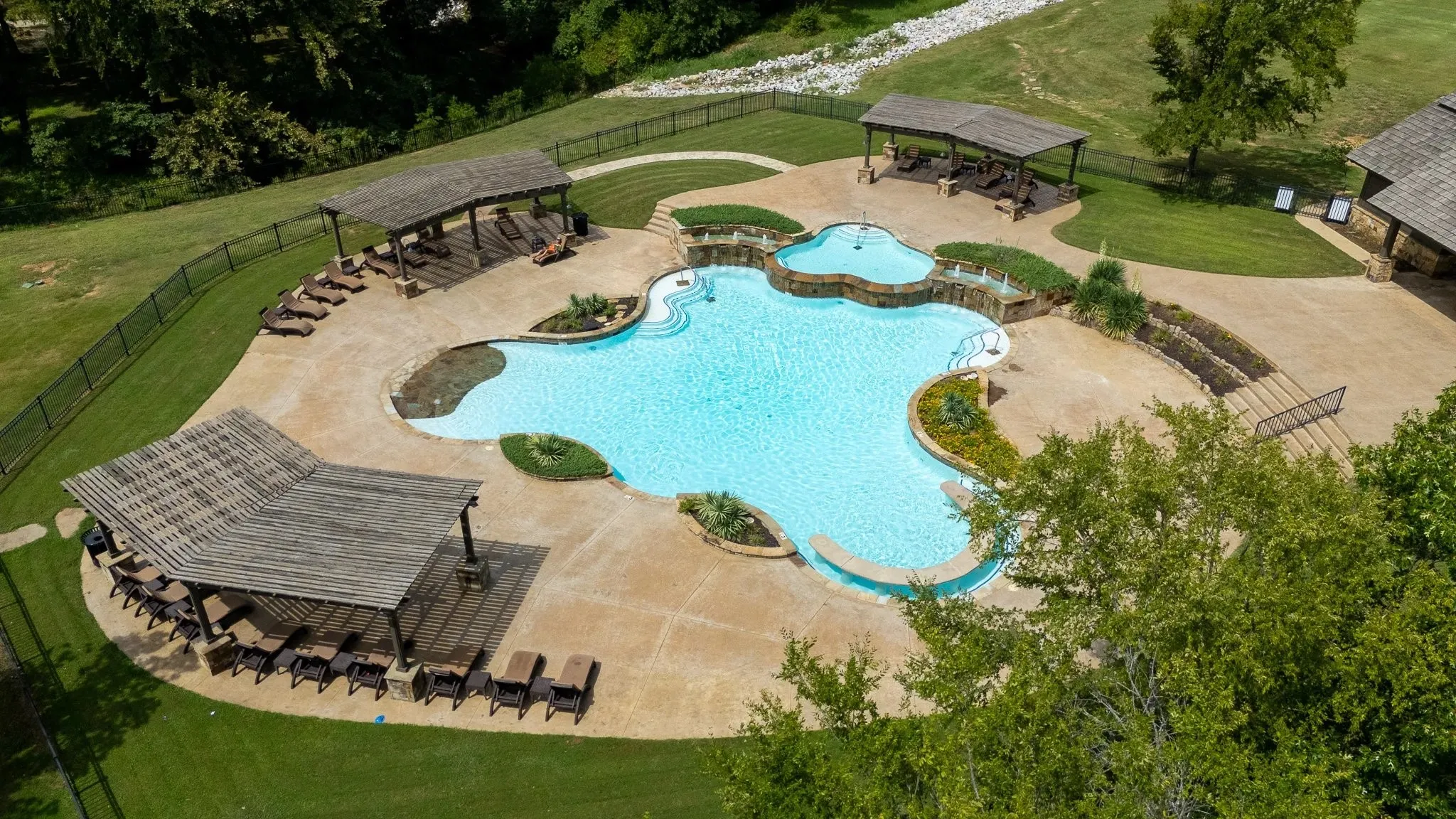 Community pool featuring a fenced backyard, a patio area, and a jacuzzi